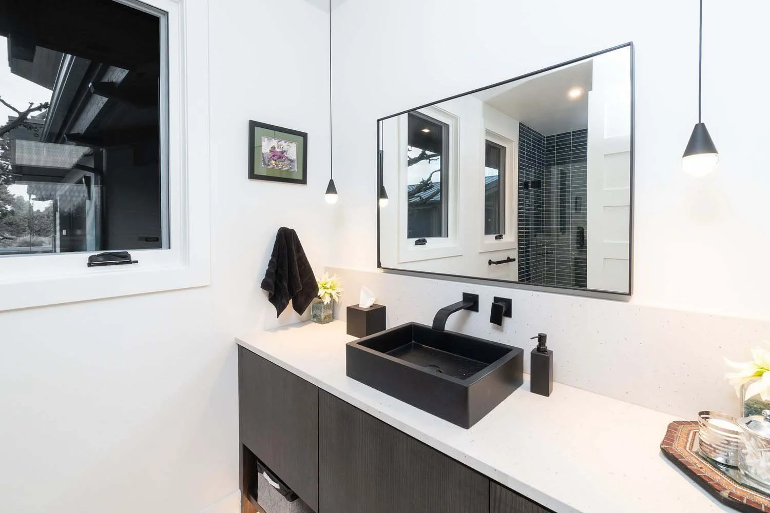 This elegant modern bathroom at Pronghorn - Canyon View is a testament to sophisticated design. The space features a clean aesthetic with crisp white walls and bold contrasts, including a stylish black modern sink and matching black fixtures. A beaut