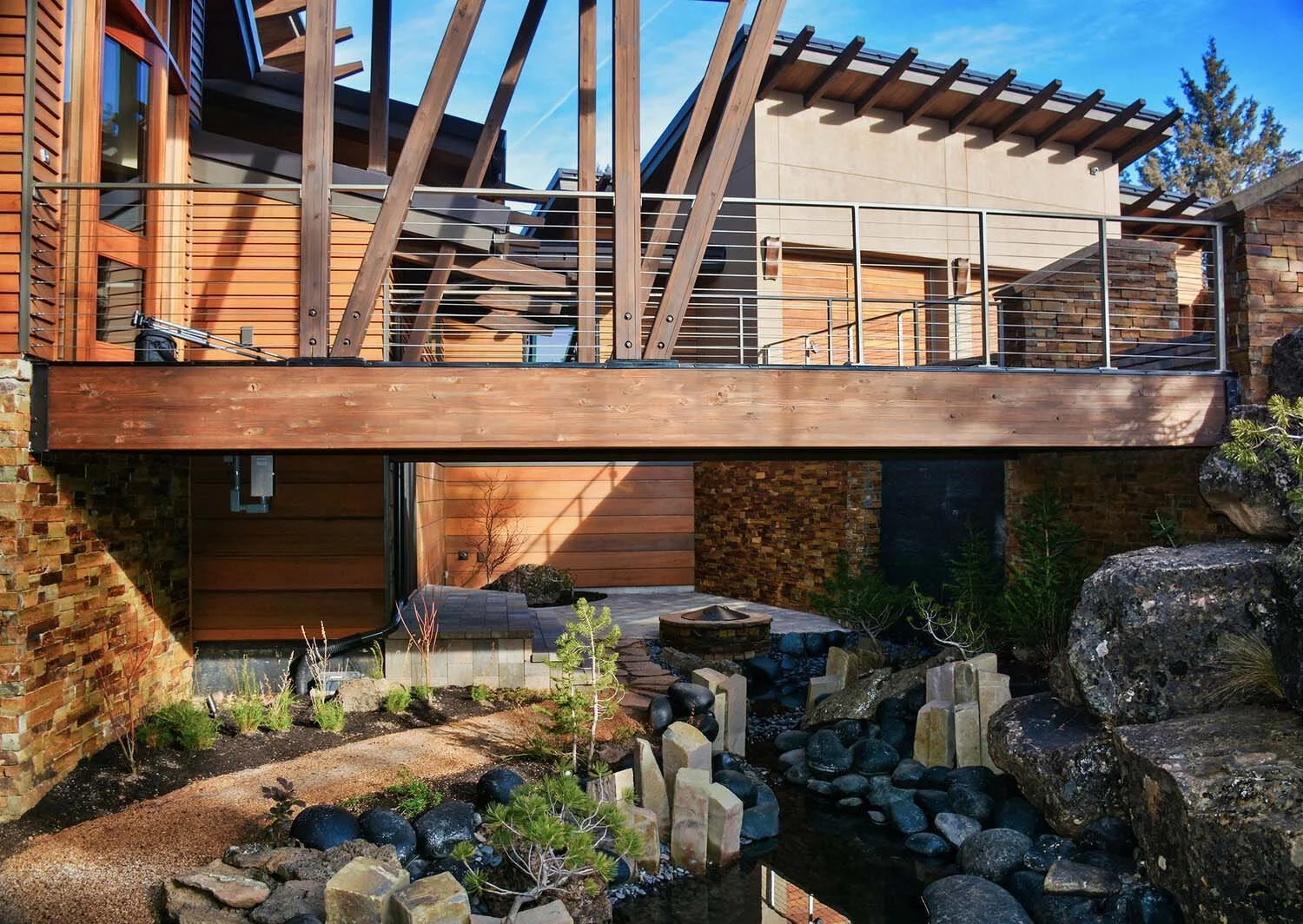 As experienced builders of luxury custom homes in Central Oregon, Pacwest Builders masterfully designed this unique residence at North Rim - Wild Rye. This image highlights the home’s distinctive front elevation, including its sophisticated wooden an