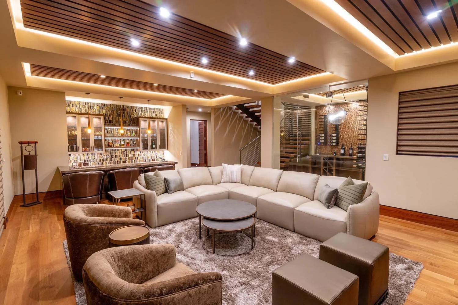 As experienced builders of luxury custom homes in Central Oregon, Pacwest Builders crafted this unique living space at North Rim - Wild Rye. The design features elegant hardwood flooring and beautiful wooden ceiling accents. The modern bar area with