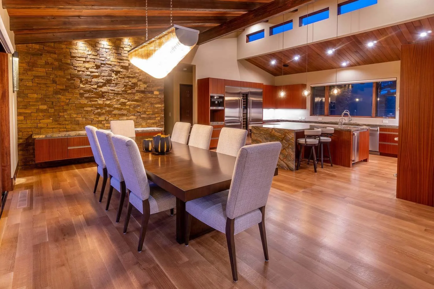 As experienced builders of luxury custom homes in Central Oregon, Pacwest Builders crafted this unique open-plan space at North Rim - Wild Rye. The design is both beautiful and functional, featuring a striking stone accent wall, warm wooden flooring,