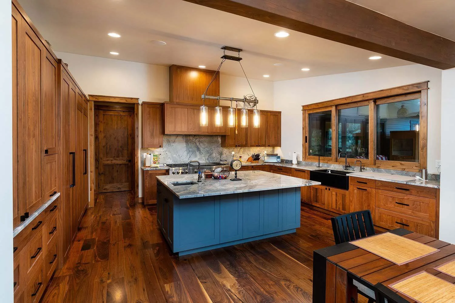 As experienced builders of luxury custom homes in Central Oregon, Pacwest Builders crafted this unique kitchen at Skyline Ranch - Imbler. The space, with interiors by Kate Dardin, is defined by its beautiful wooden cabinets and a striking blue island