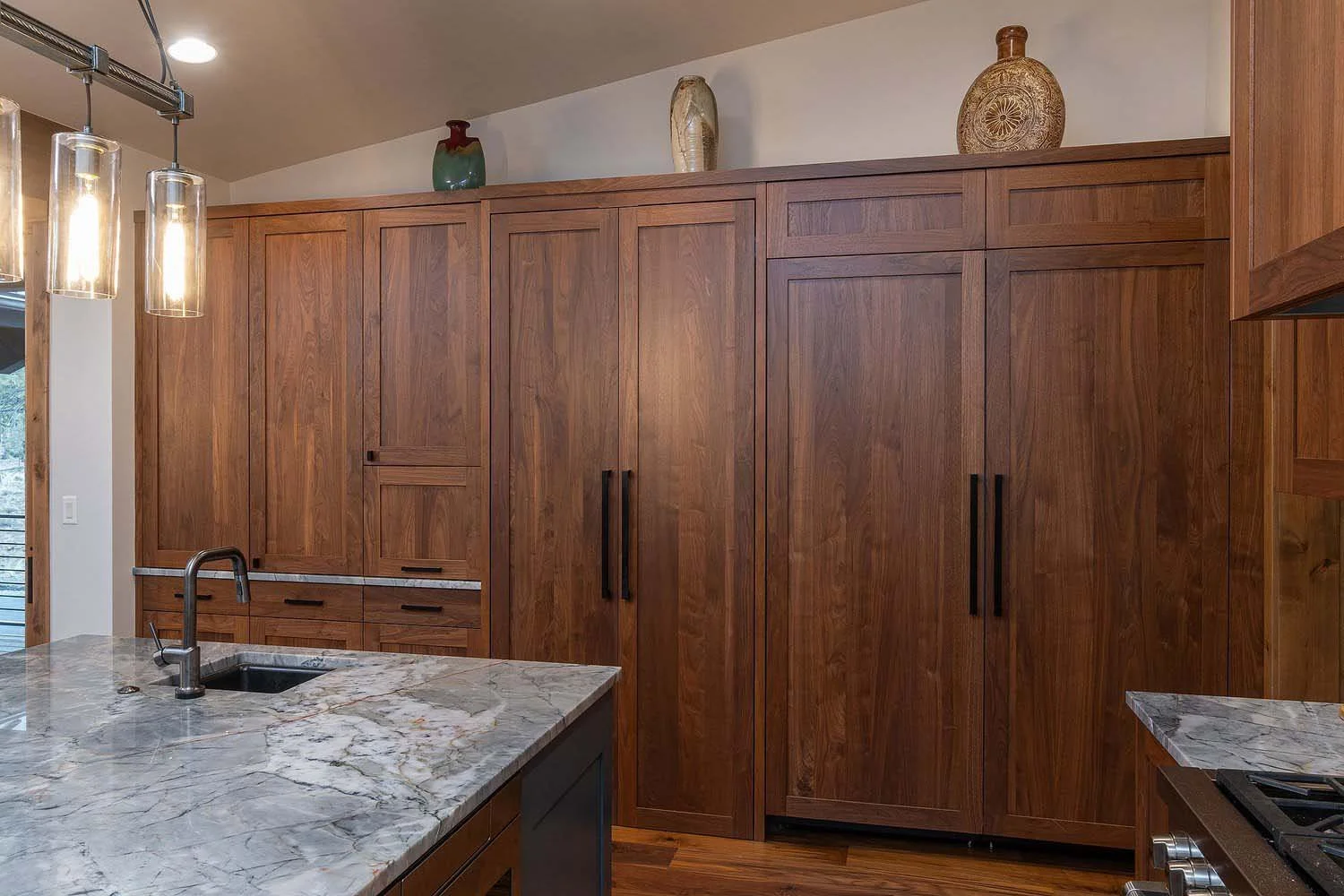 As experienced builders of luxury custom homes in Central Oregon, Pacwest Builders crafted this unique kitchen at Skyline Ranch - Imbler. The space, with interiors by Kate Dardin, is defined by its elegant wooden cabinets, a beautiful marble island,