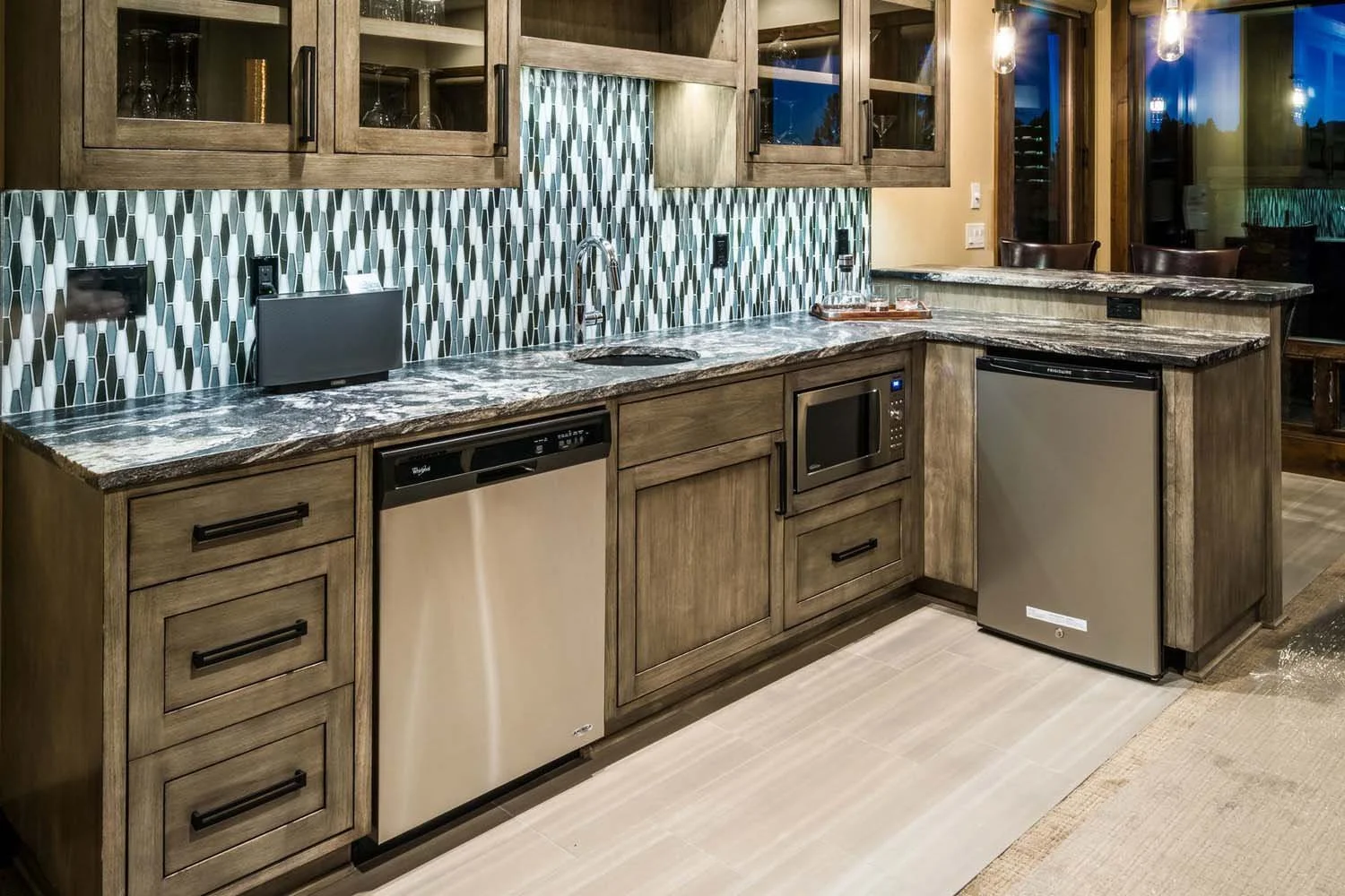 As experienced builders of luxury custom homes in Central Oregon, Pacwest Builders crafted this award-winning kitchen at North Rim - Wild Rye. This space, with interiors by Kristy Yozamp, features beautiful wooden cabinets and a sleek marble countert
