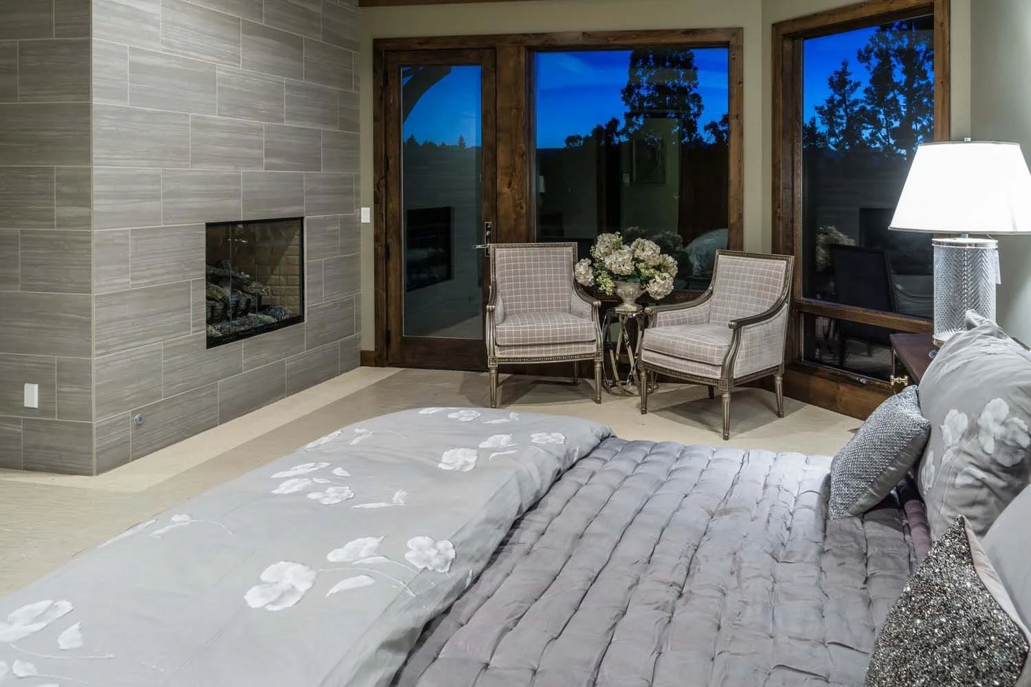 As experienced builders of luxury custom homes in Central Oregon, Pacwest Builders crafted this award-winning bedroom at North Rim - Wild Rye. The space, with interiors by Kristy Yozamp, features a grand fireplace and a serene sitting area with two u