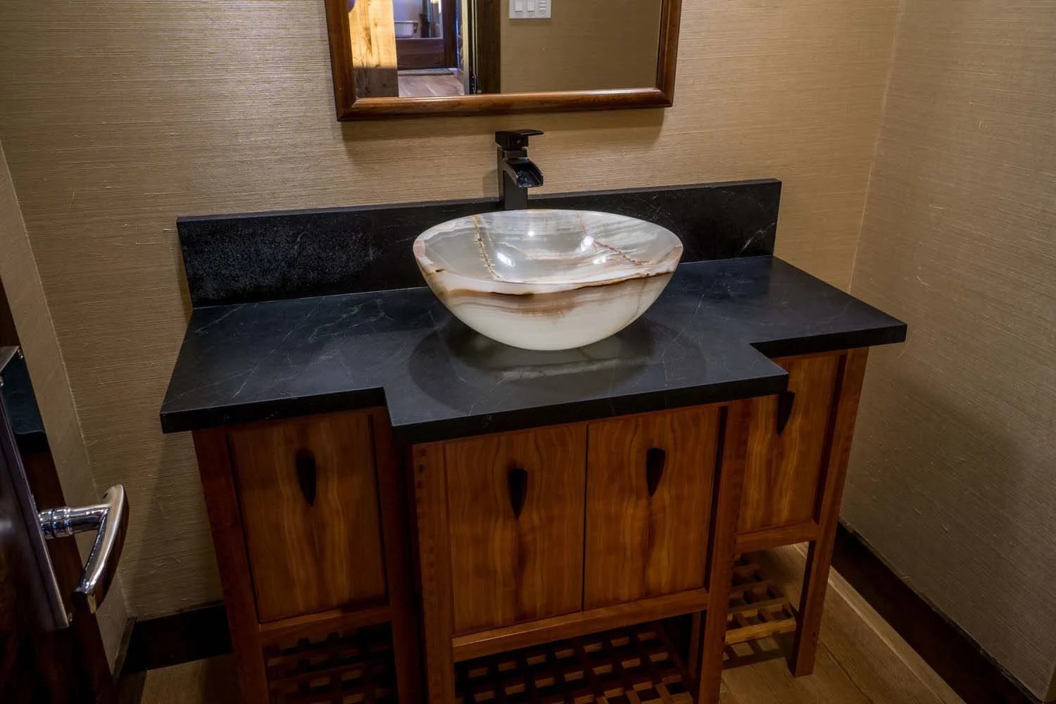 As experienced builders of luxury custom homes in Central Oregon, Pacwest Builders crafted this award-winning bathroom at North Rim - Wild Rye. This image, with interiors by Kristy Yozamp, highlights a one-of-a-kind decorative marble vessel sink and