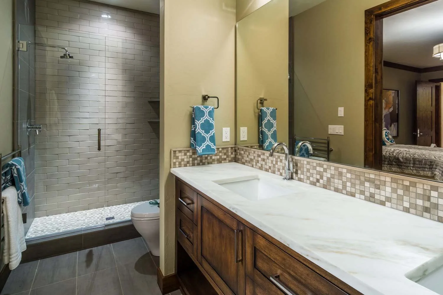 As experienced builders of luxury custom homes in Central Oregon, Pacwest Builders crafted this award-winning bathroom at North Rim - Wild Rye. This space, with interiors by Kristy Yozamp, highlights a stunning glass-enclosed shower and a beautiful w