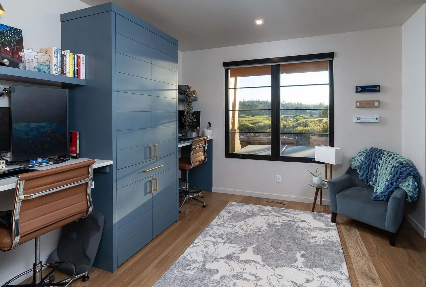 As experienced builders of luxury custom homes in Central Oregon, Pacwest Builders crafted this unique residence at Tetherow - Hardin Martin Court. This modern home office is designed to be a serene and productive workspace. The beautiful wooden floo