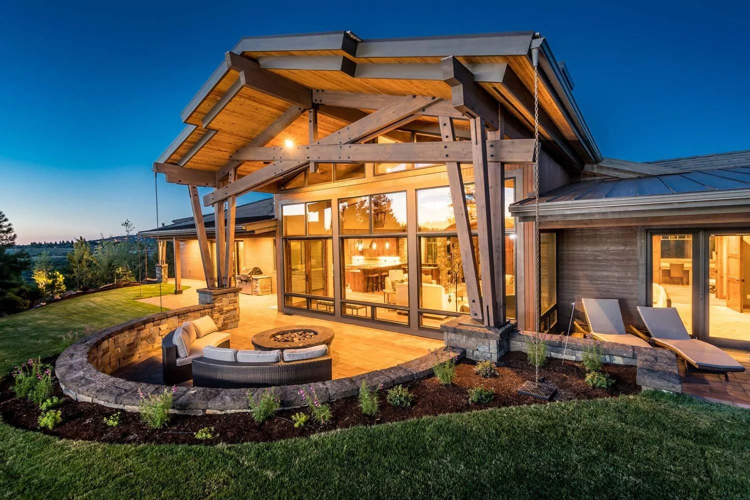 Pacwest Builders masterfully designed this stunning mountain modern luxury custom home in Central Oregon, at Tetherow - Hawk Court. The home, designed by Spencer Williams, highlights its striking modern architecture, including its large glass windows