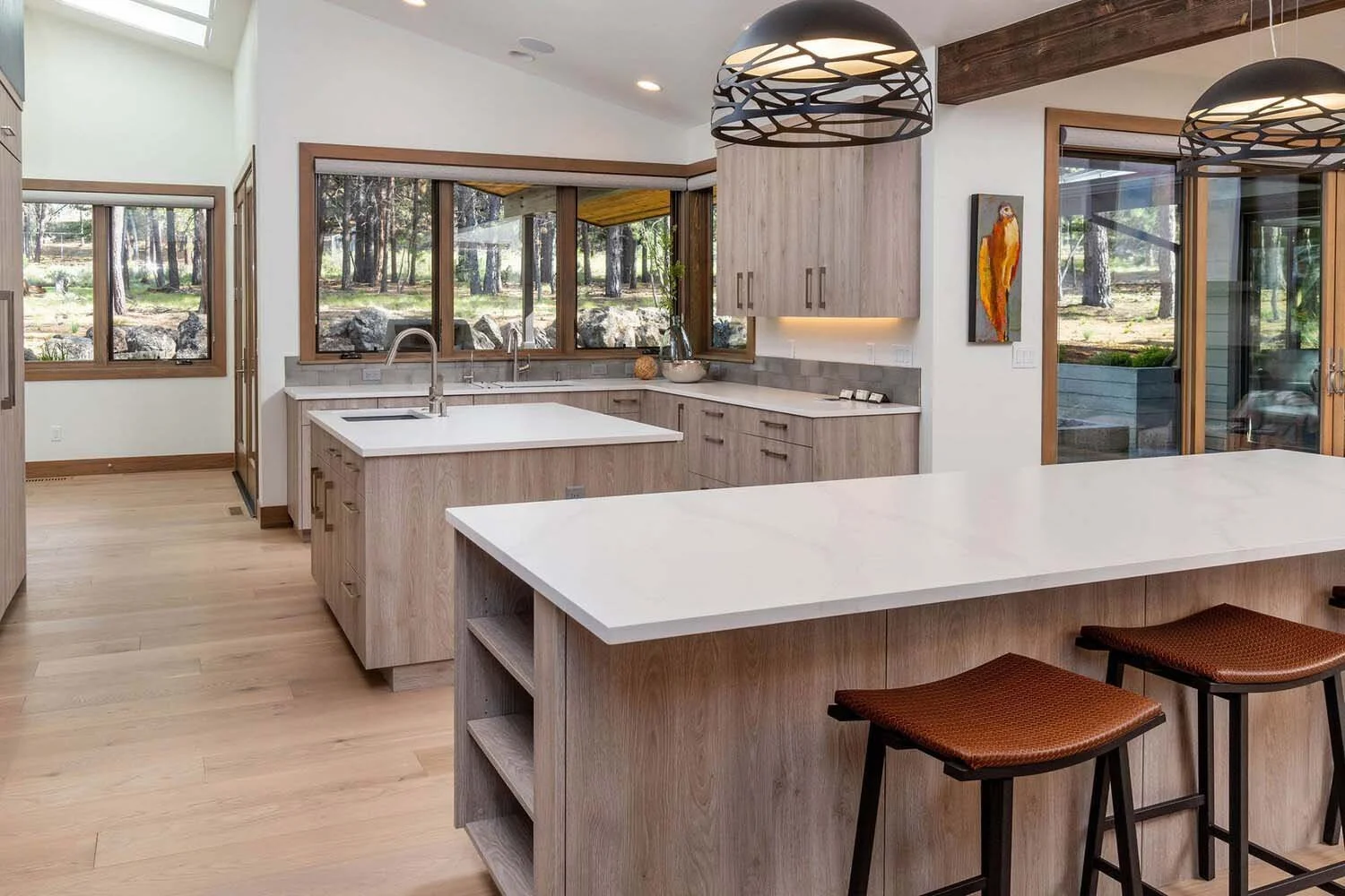 This stunning modern kitchen in the "Best Kitchen" winning in the 2017 COBA Tour of Homes. This Tetherow - Meeks Trail home is a perfect blend of style and functionality. The space features elegant light wood cabinets, a beautiful large island with a