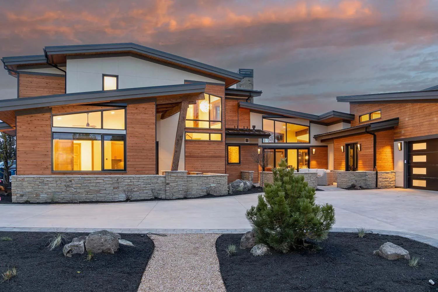Explore the stunning architecture of this luxury custom home in Central Oregon's Pronghorn - Switchback. Designed by Blair Davis, this house features a contemporary exterior with a mix of wood and stone. Pacwest Builders and Kate Darden worked togeth