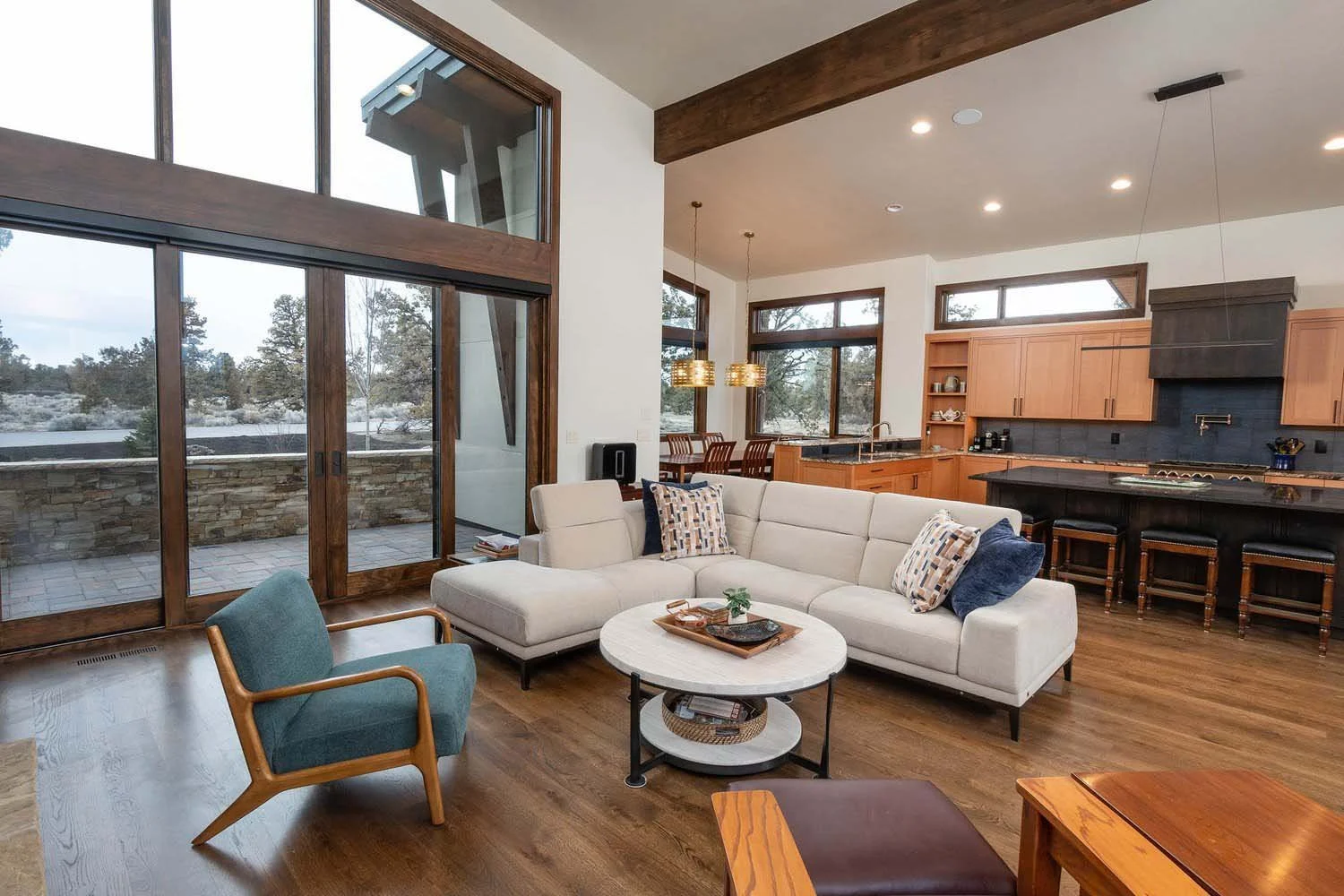 The bright and airy interior of this Pronghorn - Switchback home highlights its impeccable interior design by Kate Darden. Working with Pacwest Builders, the team selected wooden floors by Pinnacle Hardwood Floors and large windows by Sierra Pacific