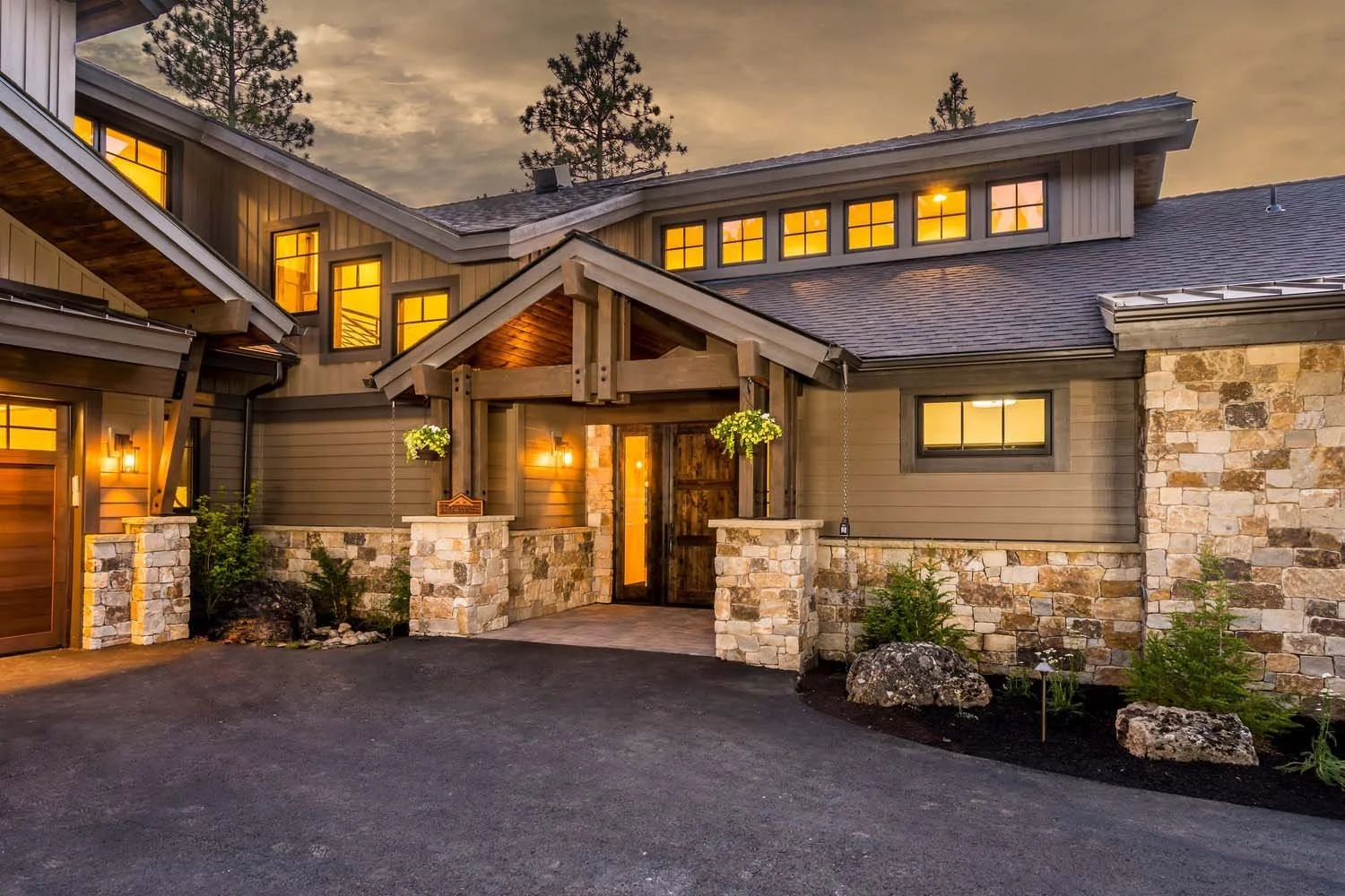 Explore the award-winning architecture of this residence in Tetherow - Bainbridge Court. As a 2017 COBA Tour winner for "Best of Show" and "Best Landscape," this mountain modern home features a striking stone and wood exterior and a covered front por