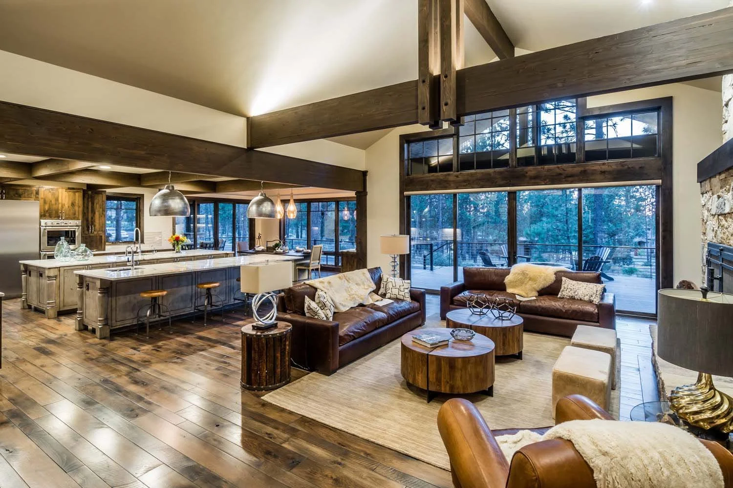 This open-concept living room and kitchen, part of a luxury custom home in Tetherow - Bainbridge Court, is a showcase of masterful interior design by Kristy Yozamp. The space, a 2017 COBA Tour winner for "Best Interior Design," features beautiful woo
