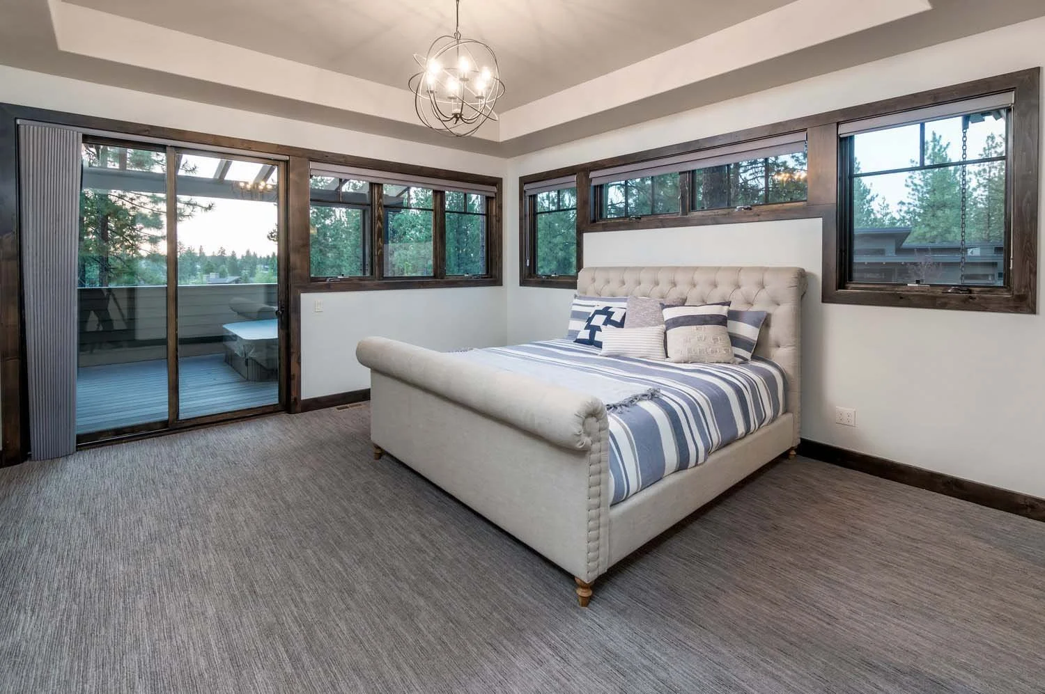 This inviting bedroom, a highlight of a luxury custom home in Tetherow - Bainbridge Court, is a showcase of sophisticated interior design by Kristy Yozamp. The space, a 2017 COBA Tour winner for "Best Master Suite" and "Best Interior Design," feature