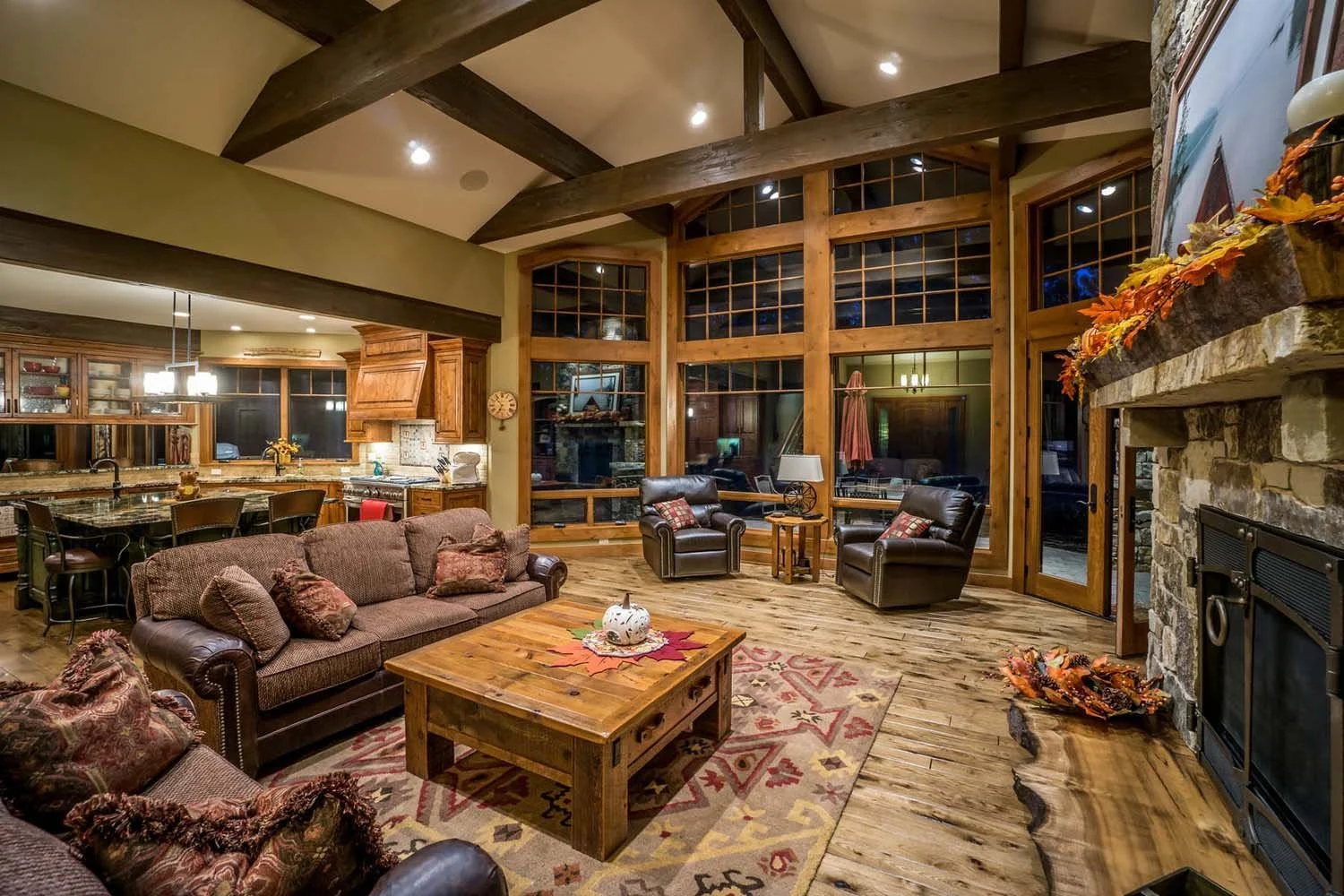 Designed by Spencer Williams with interiors by Kristy Yozamp, this mountain modern living room won "Best Architectural Design" and "Best of Show." The space features warm wooden floors, a stunning stone fireplace, and large windows that bring in the