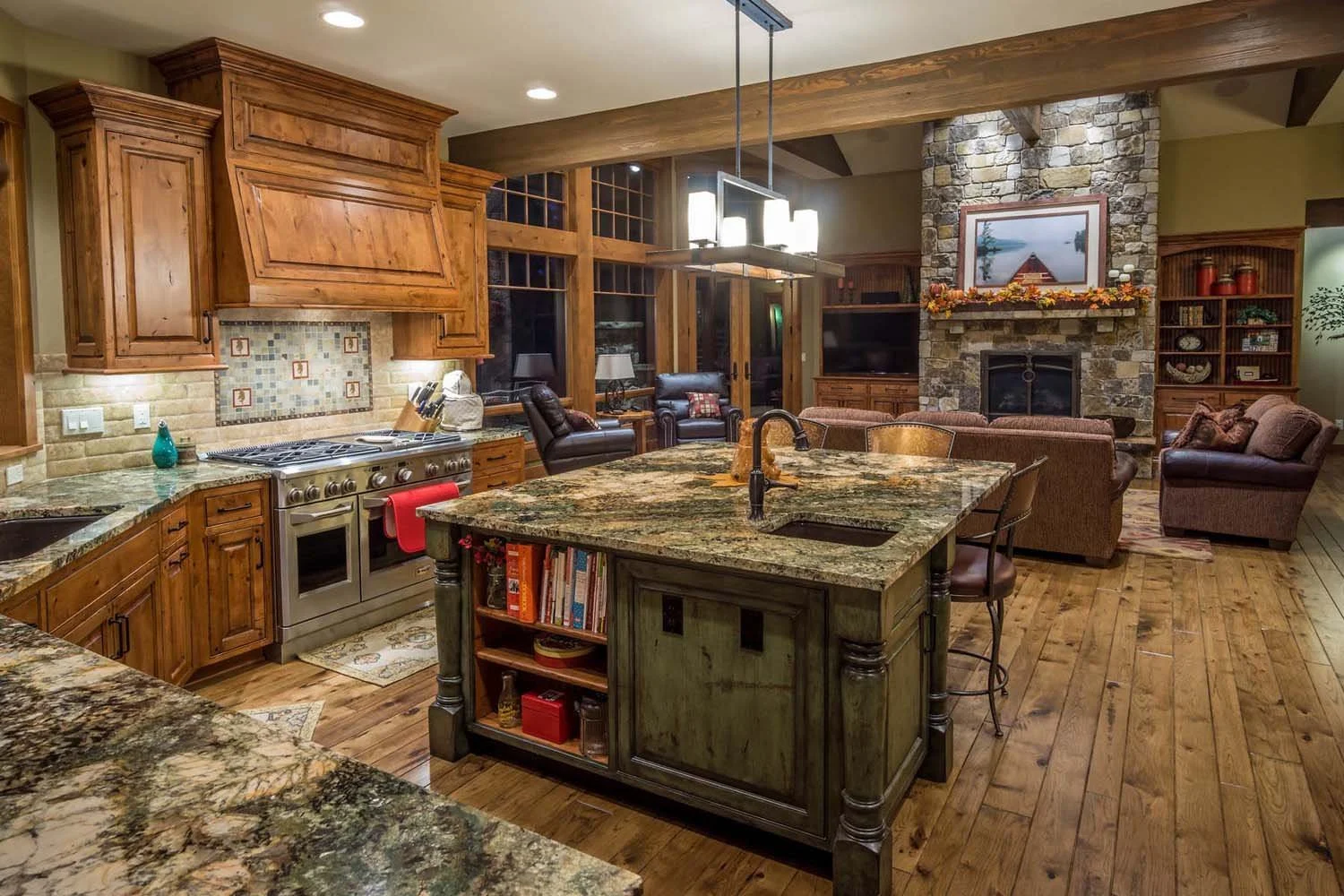This open-concept kitchen and living room, part of the "Best of Show" and "Best Kitchen" winning Caldera Springs - Fireglass Loop home, showcases mountain modern design by Spencer Williams and Kristy Yozamp. The space features a seamless flow from th