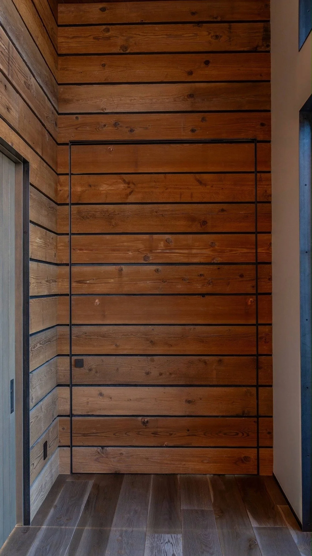 We love how this door creates such a grand, yet subtle entrance. This interior pivot door was built by On Time Fabrication in Central Oregon. #pivotdoor #dreamhomes #customhomes #barnwood