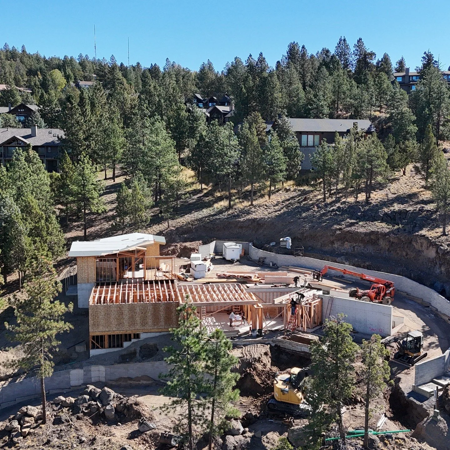 Getting up this Awbrey Butte lot required creativity, planning, and excavators! Massive retaining walls were built into the hillside to safely bring the driveway up 30+ feet. Now, this mountain modern beauty is taking shape. Soon, a wall of glass wil