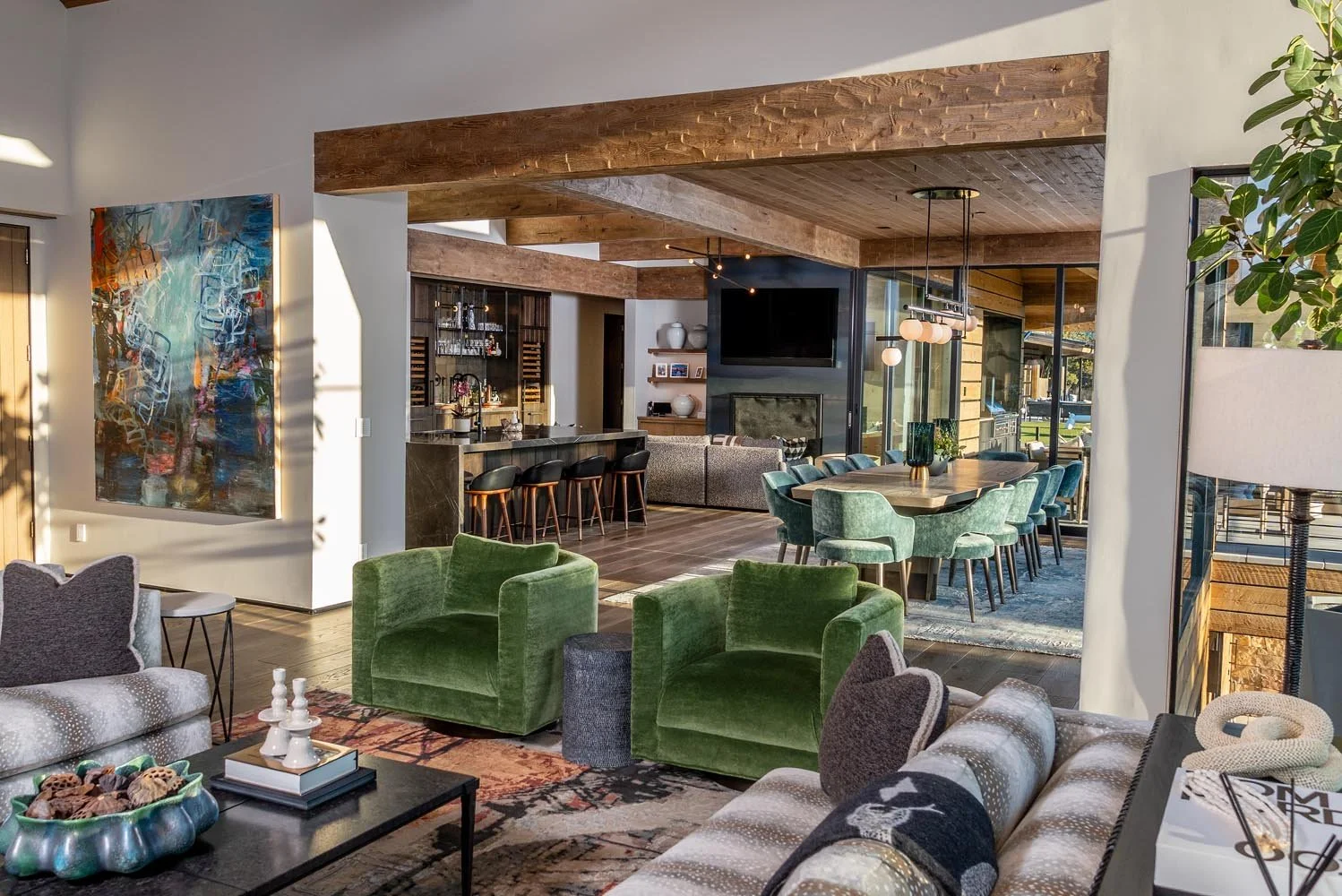 This spacious open-concept living space at Pacific Cascade Heights is a perfect blend of style and comfort, a testament to Pacwest Builders' expertise in mountain modern design. Striking wooden beams from Beamworks USA define the ceiling, while the i