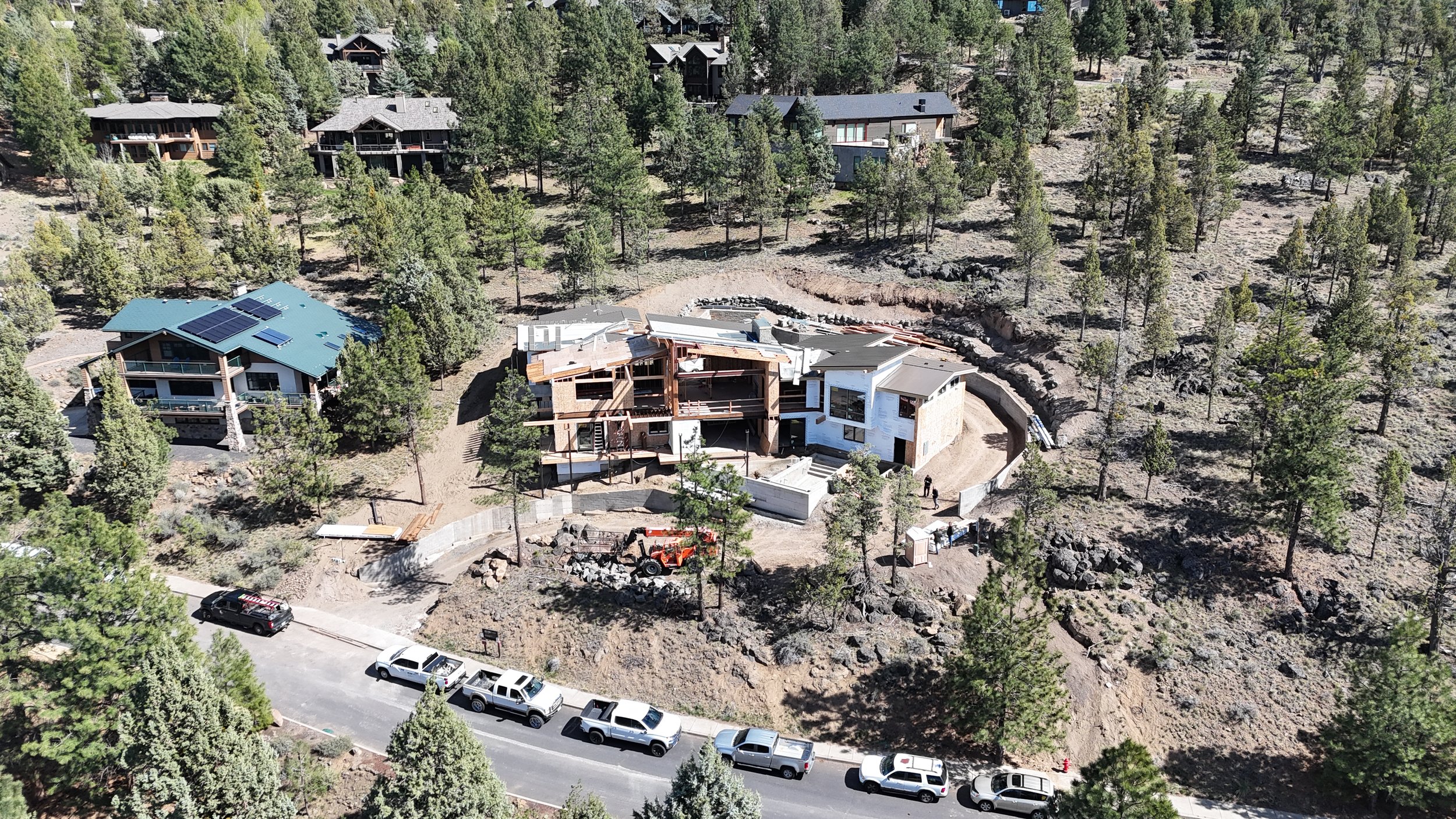 This aerial view of our latest Awbrey Butte project captures a custom modern home taking shape in Bend, Oregon by Pacwest Builders.