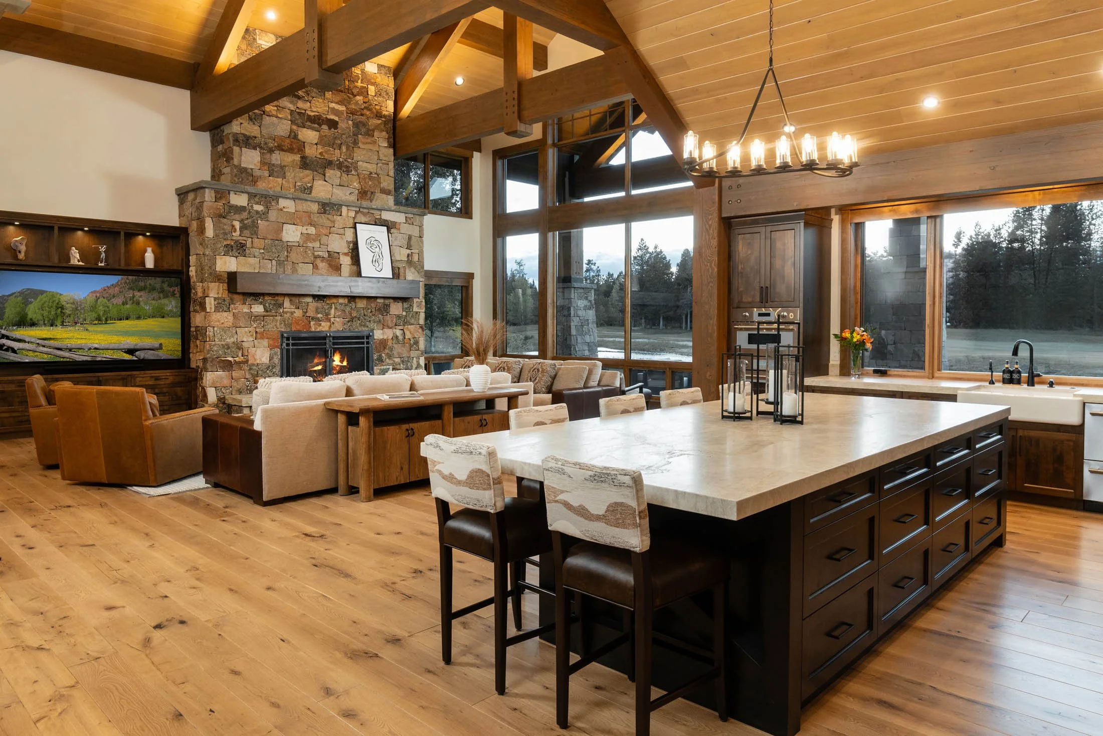 Luxury great room with a vaulted ceiling and massive timber beams in a Crosswater custom home designed by Spencer Williams and built by Pacwest Builders.