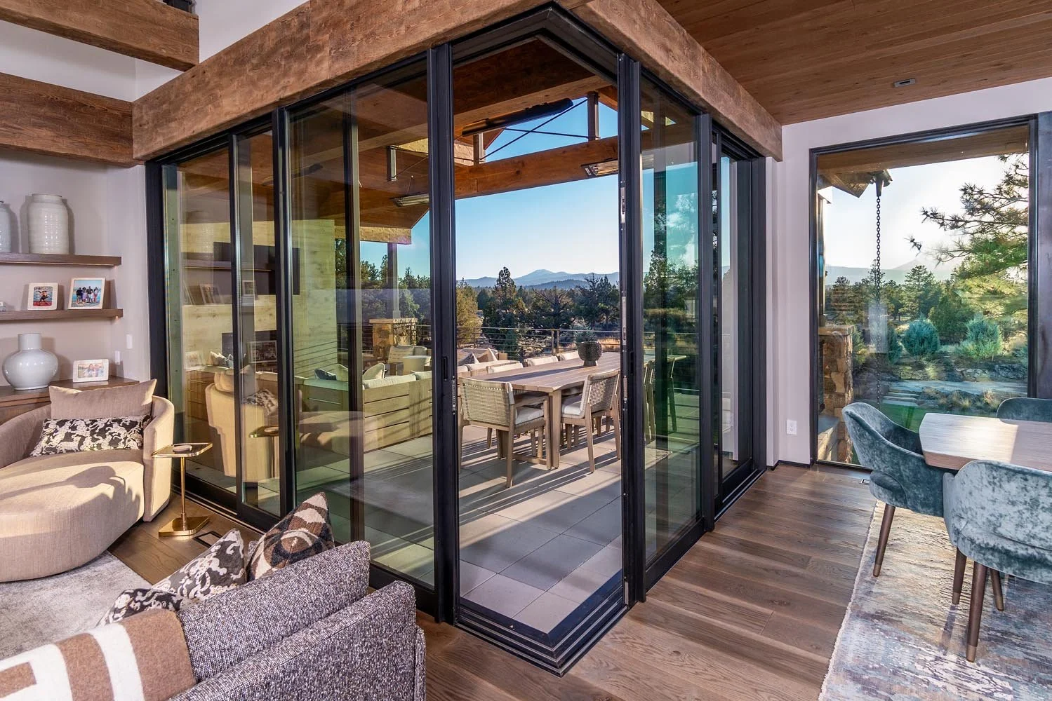 Designed to merge the home with its natural surroundings, the living room at Pacific Cascade Heights features a spectacular corner glass door system by Fleetwood Windows and Doors. This striking unit, a hallmark of the masterful architectural design