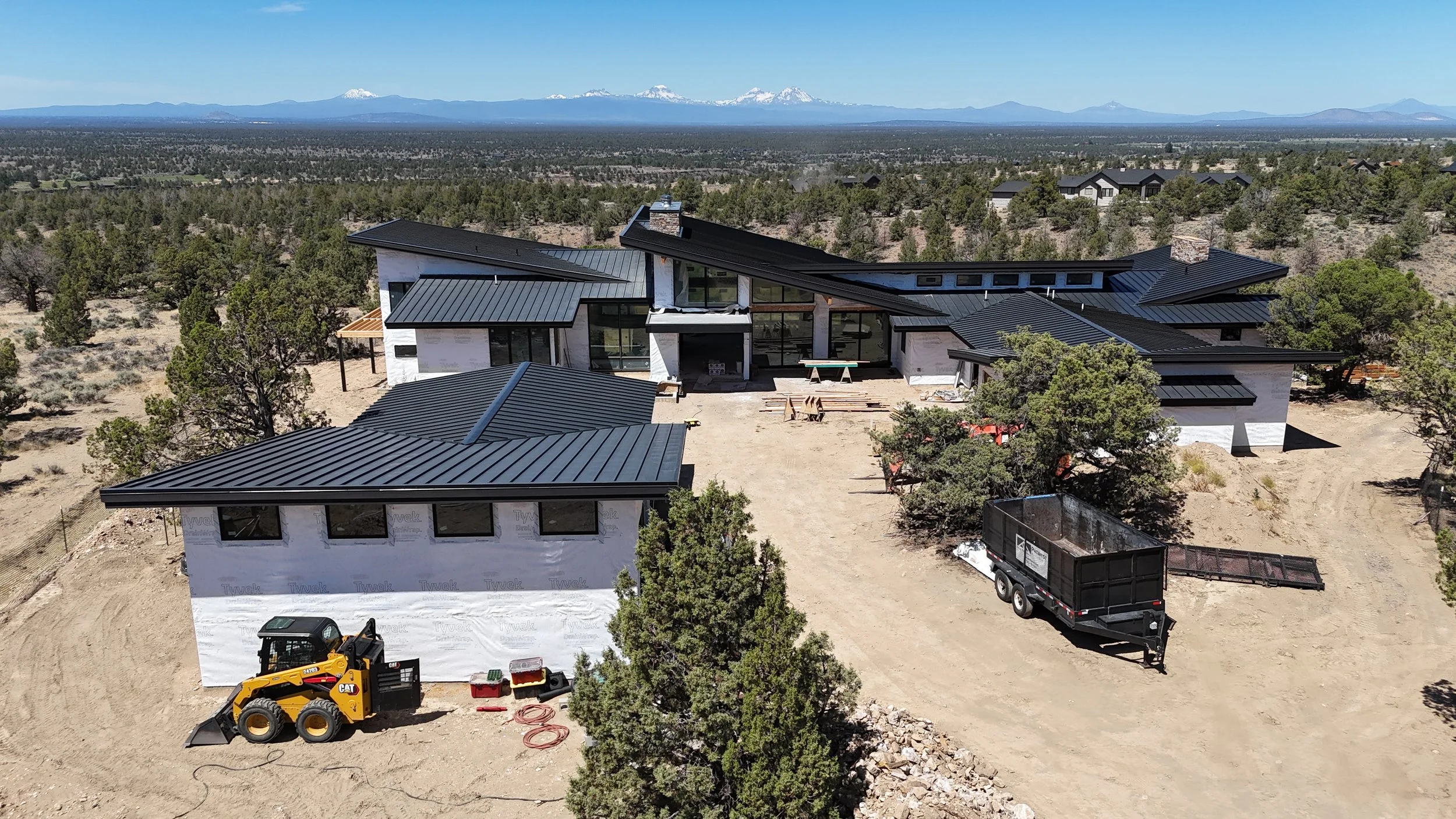 Mountain modern masterpiece in Brasada Ranch designed by Spencer Williams and Pacwest Builders, featuring massive stone walls and floor-to-ceiling windows.