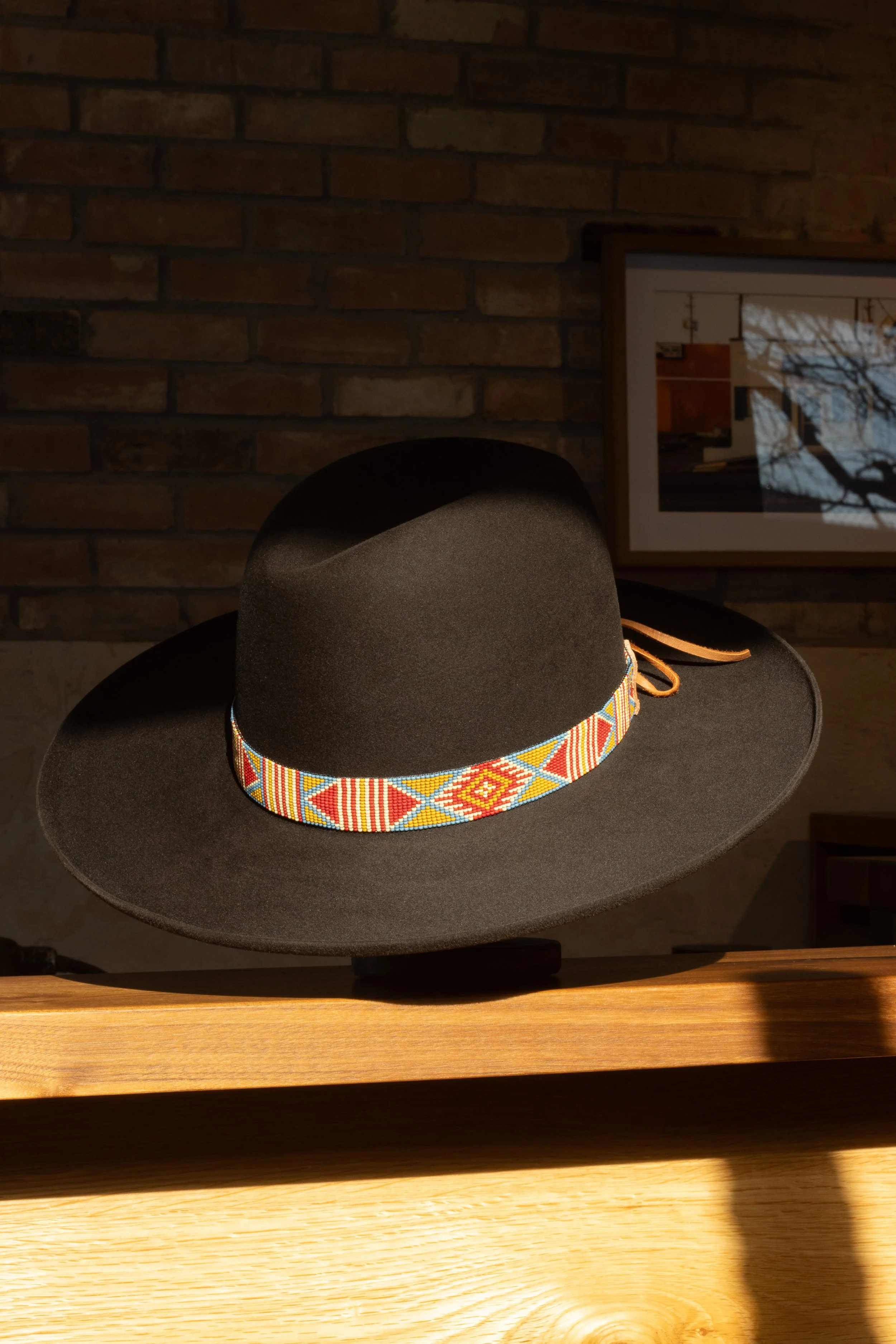 A dark brown colored pure beaver hat with a hand loomed native style beaded band. Vintage style handmade hat.