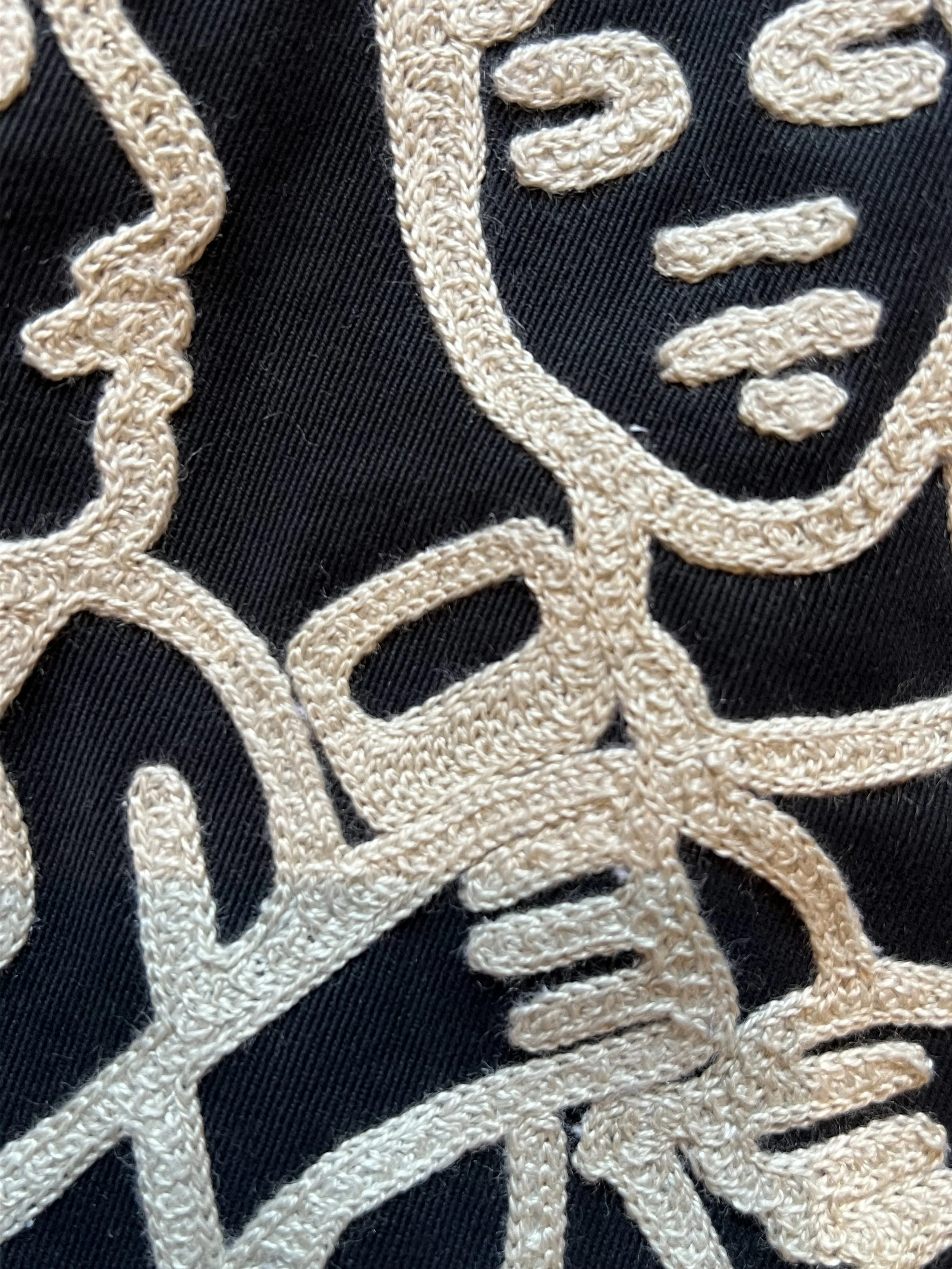 Closeup of a custom chainstitched uniform shirt stitched by local Dallas store Rhode and Sons. We specialize in custom handmade hats, hand cranked chainstitch embroidery and clothing.