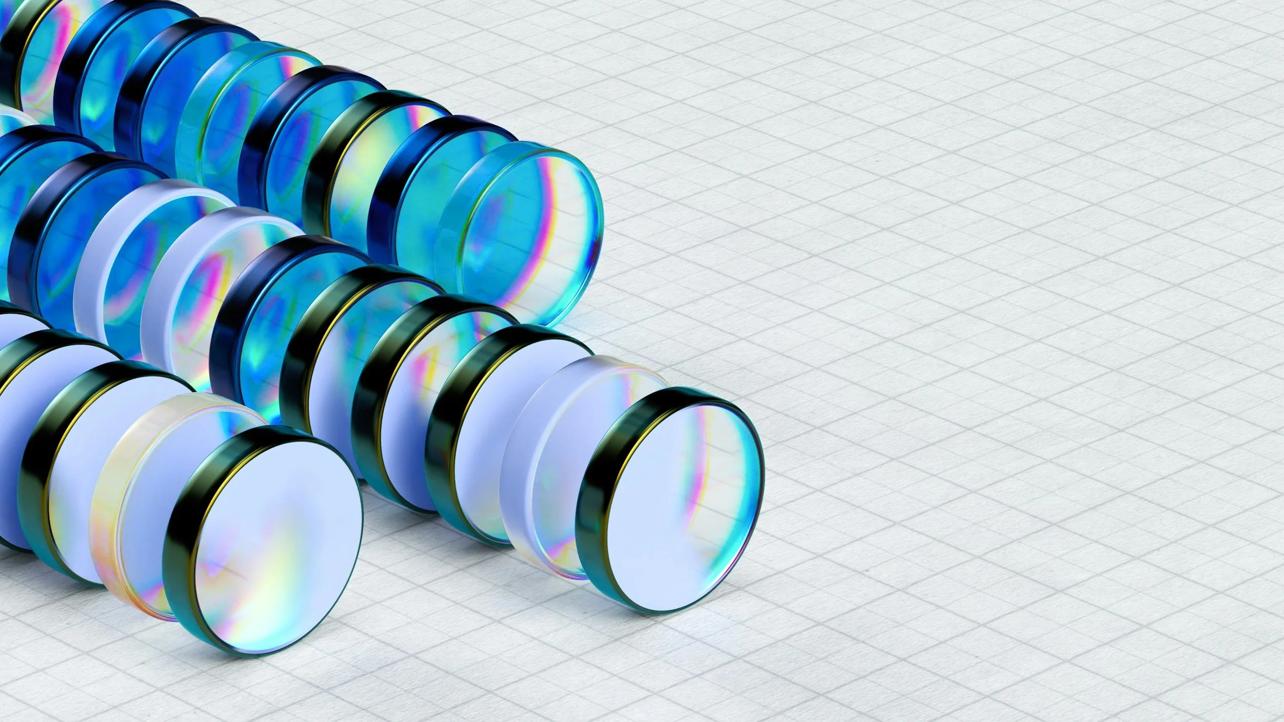 Multiple compact discs with holographic reflections arranged on a light grid-patterned surface.