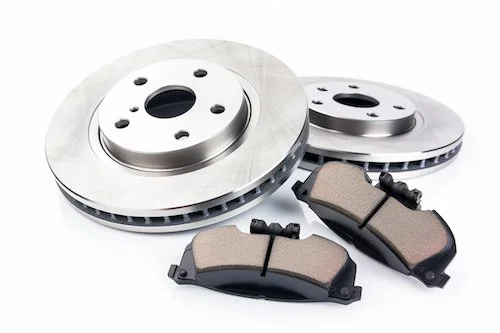 Two car brake rotors and brake pads on a white background.