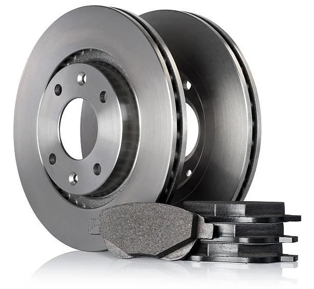 Two metal brake discs and brake pads for a vehicle.