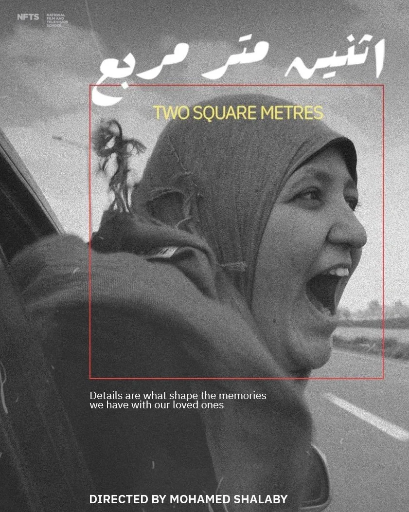 Black and white photo of a woman with a headscarf, smiling and looking out of a vehicle window on a highway.
