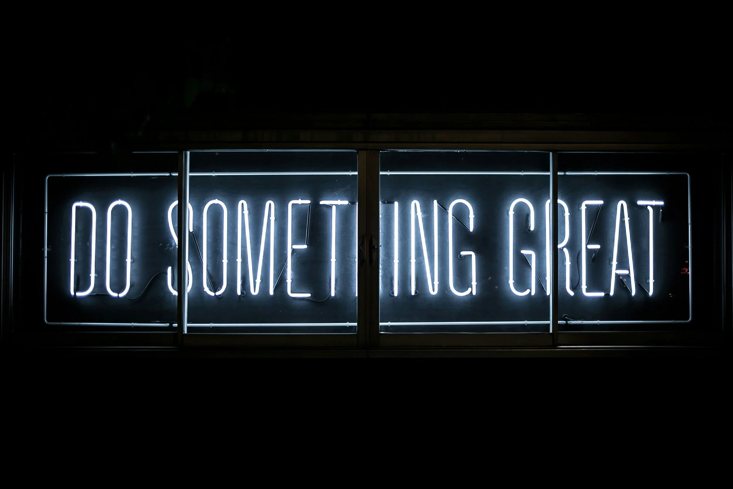 A neon sign that says do something great