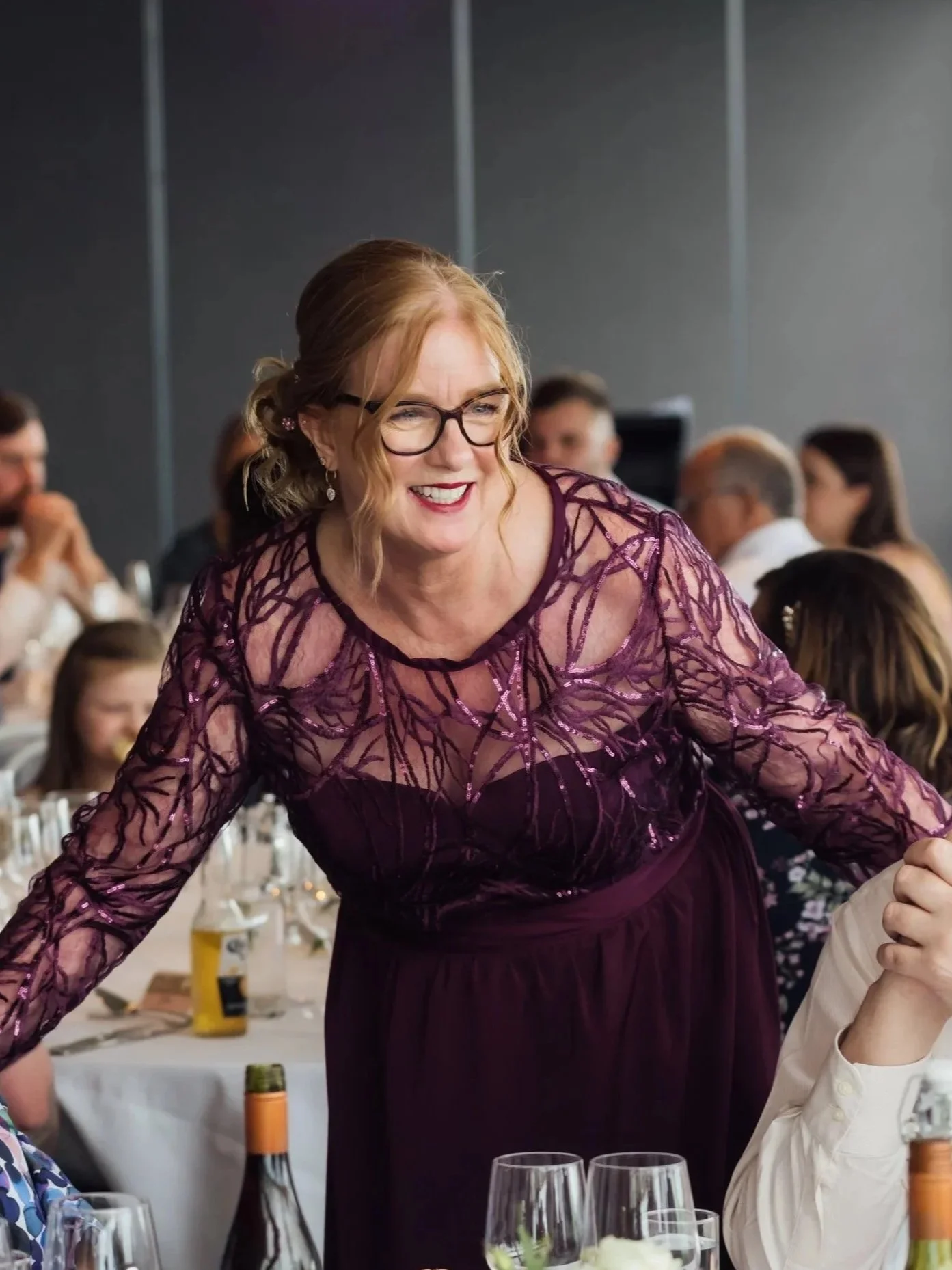 Amanda of Confetti & Lace, smiling at a wedding