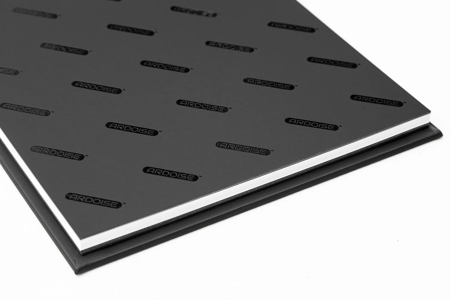 A black hardcover notebook with the brand name 'ARDOISE' repeatedly printed on the cover in black letters.