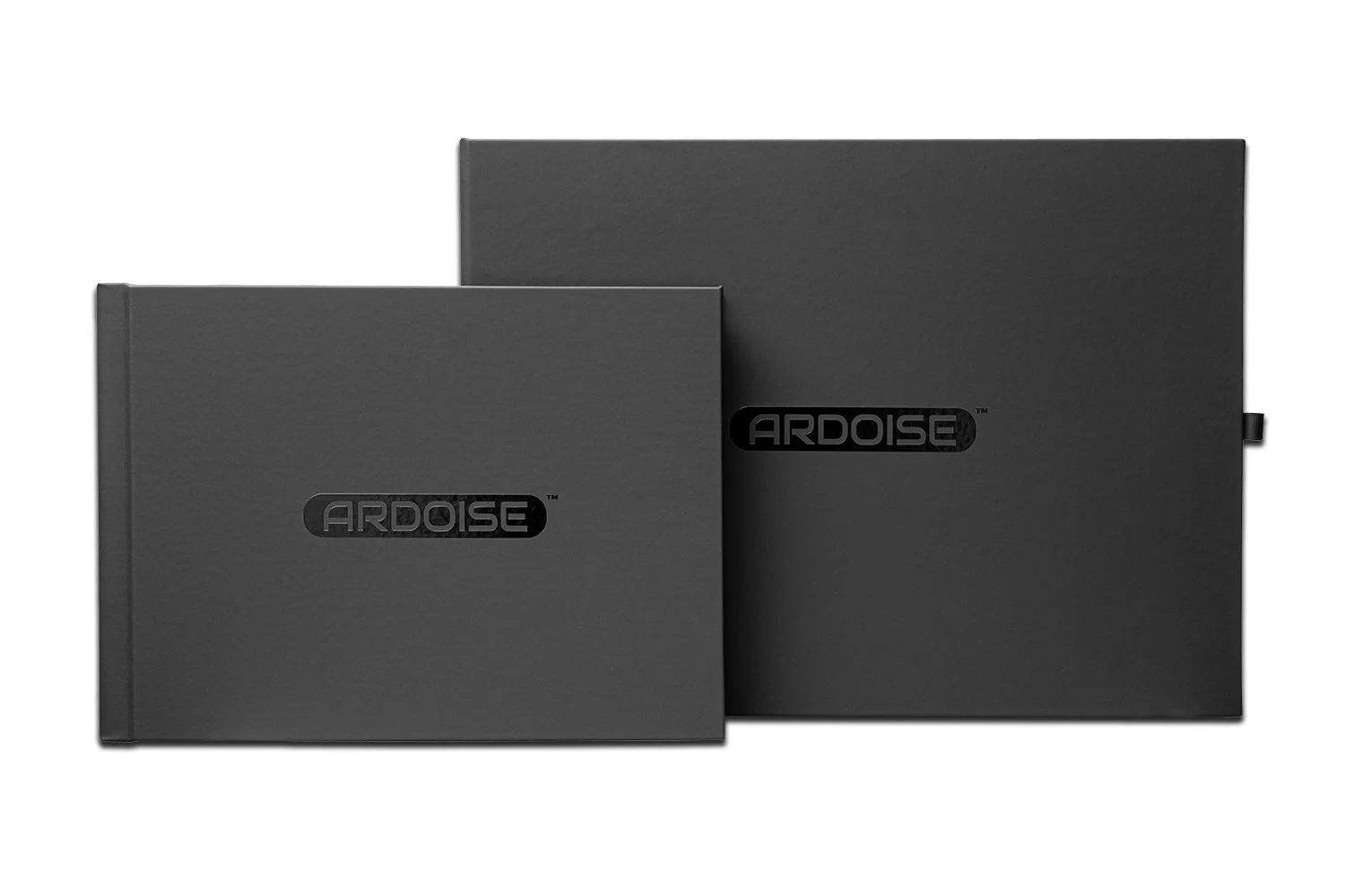 Two black boxes with the brand name ARDOISE printed on the front, one smaller in front of a larger one, both appearing to be packaging for a product.