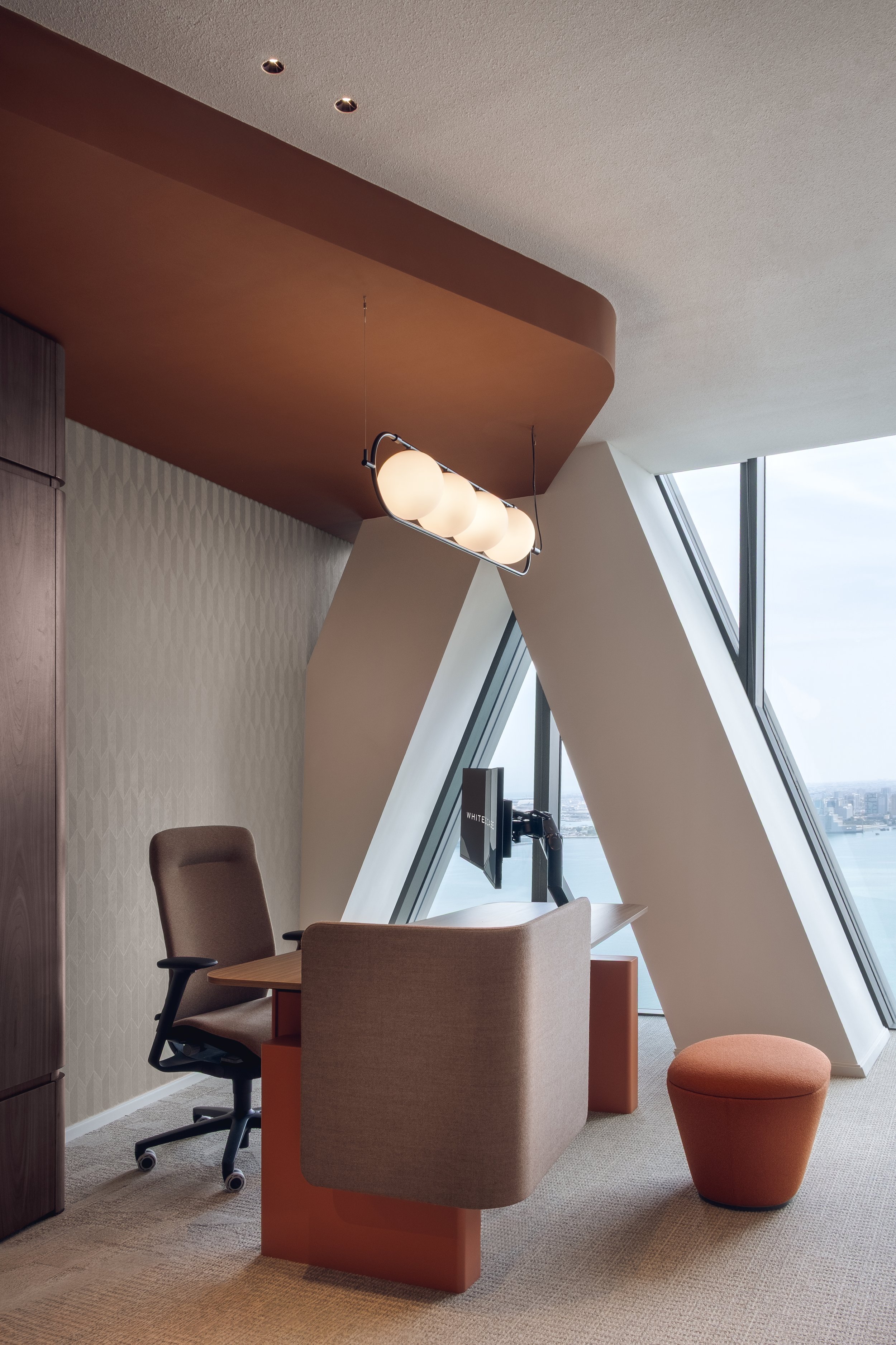 Private workspace with desk and city view inside the White and Case office in Tornado Tower Doha interior architecture photography by Pedro Ferr