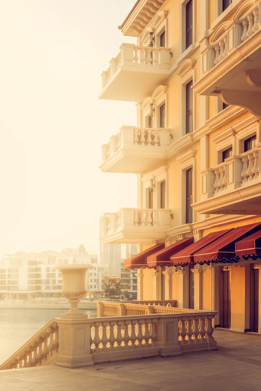 Qanat Quartier waterfront façades at golden hour — premium residential architecture in Doha