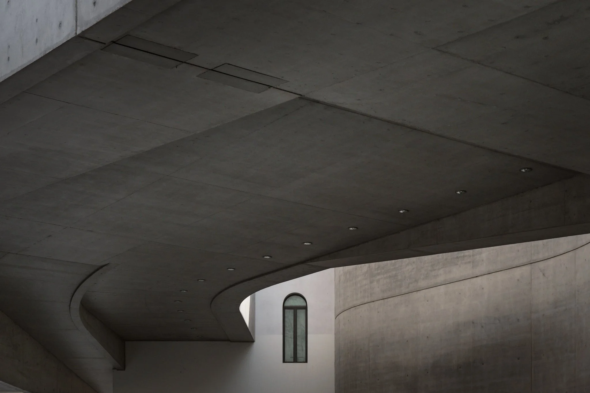 Detail of horizontal concrete overhang at MAXXI Rome, structural edge and shadow against the building facade below.