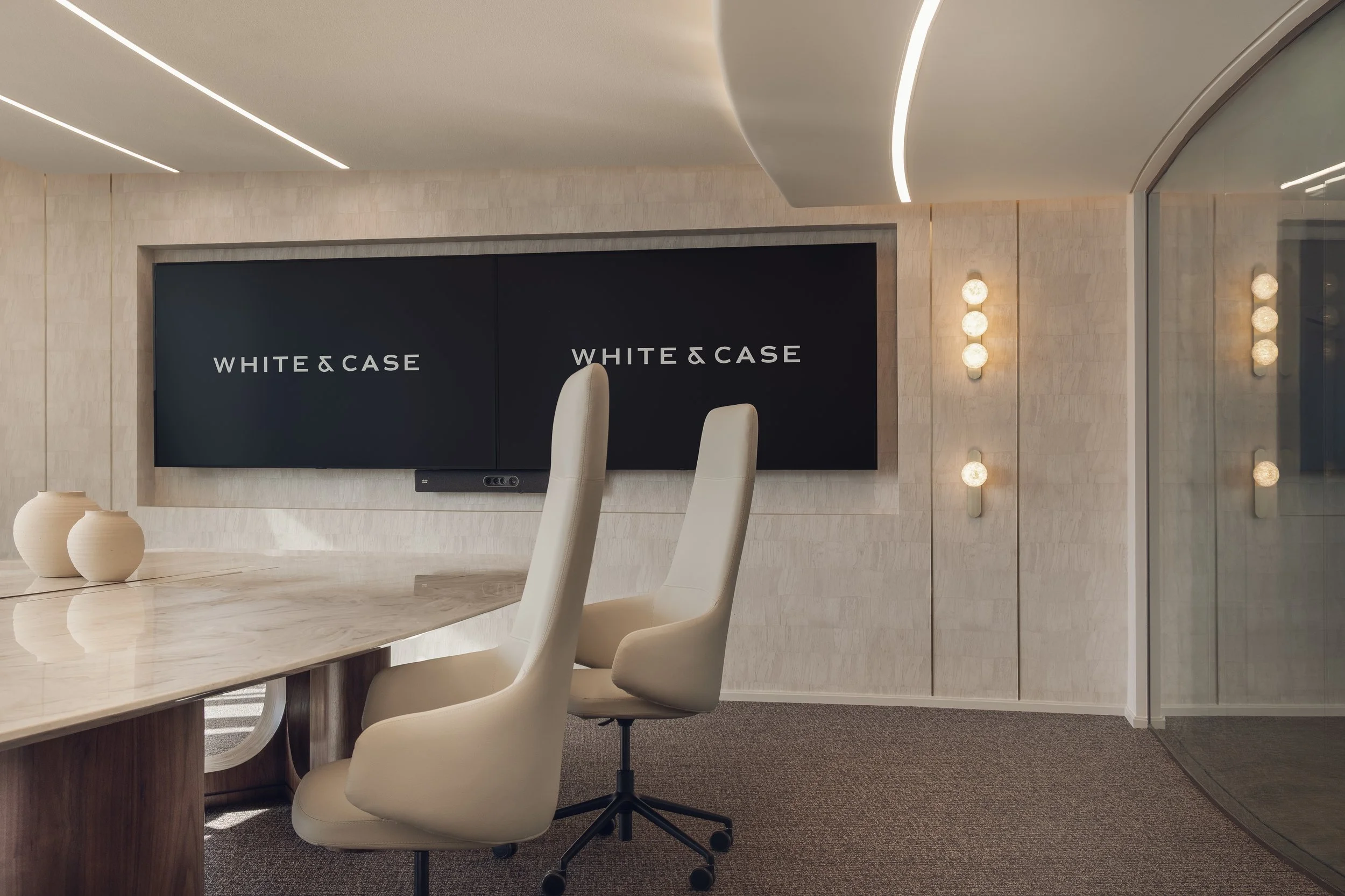 Meeting room at White & Case law office in Tornado Tower Doha photographed with curved ceiling lighting and integrated screen wall by architectural photographer Pedro Ferr