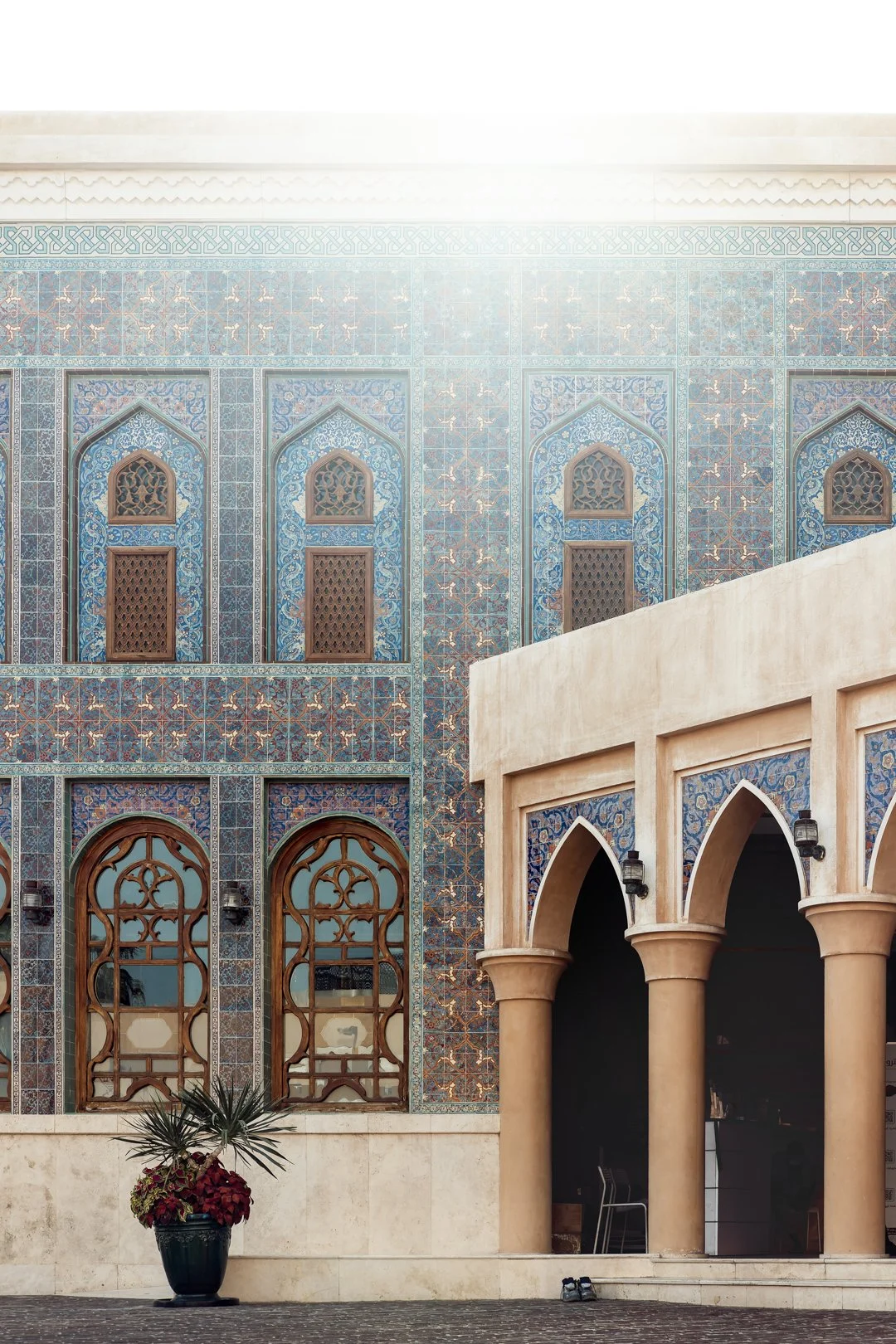 Katara Mosque blue mosaic wall with arched wooden windows and traditional Islamic patterns in Doha, Qatar