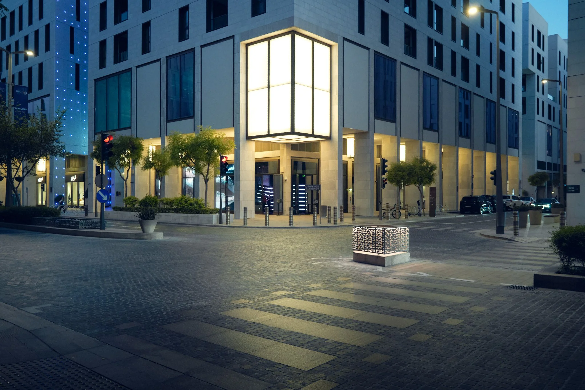 Night architectural photography of a contemporary building facade in Msheireb Downtown Doha, Qatar, featuring clean geometric lines and warm interior lighting. Shot by Pedro Ferr