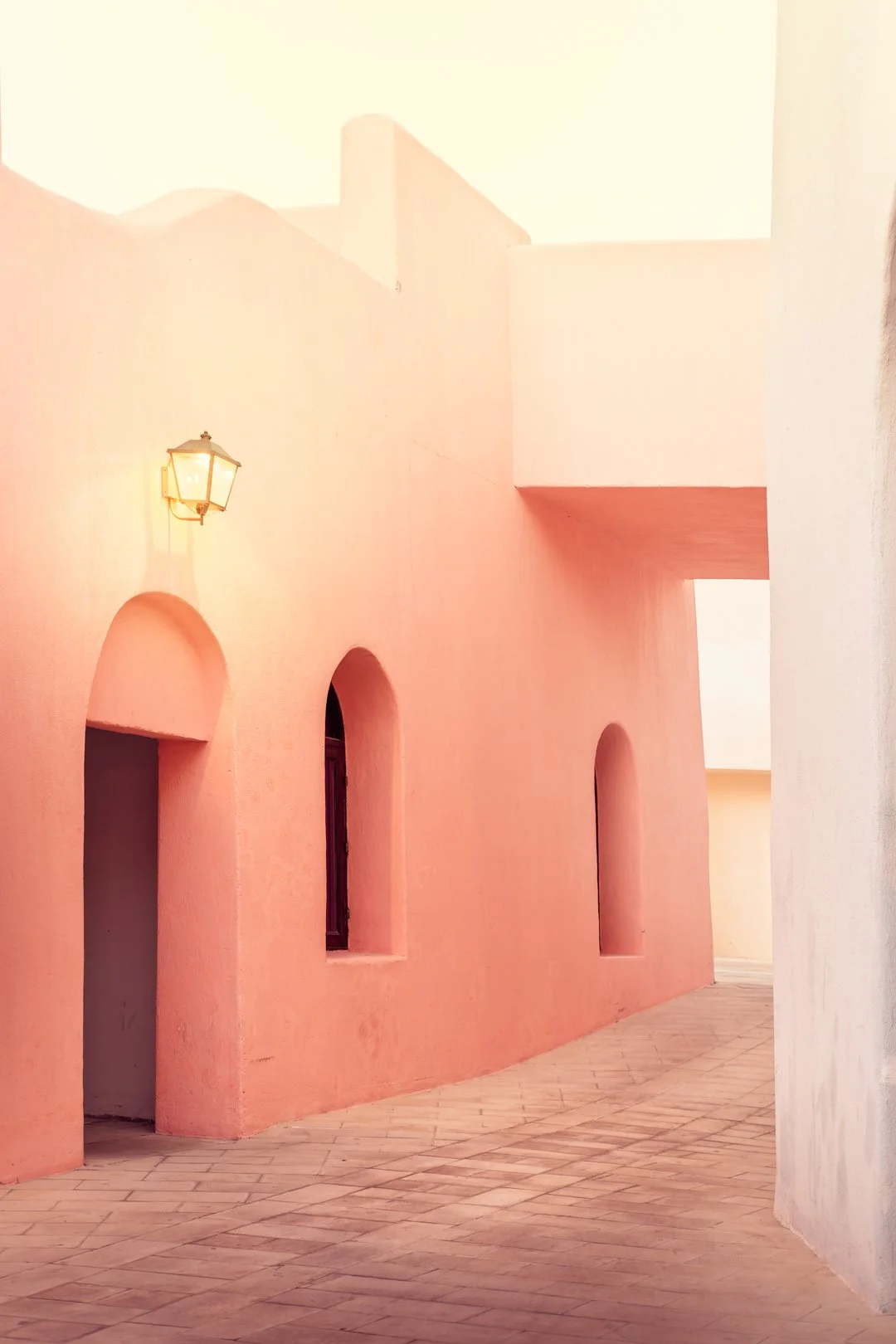Mina District pastel pink façades and archways — lifestyle architecture in Doha