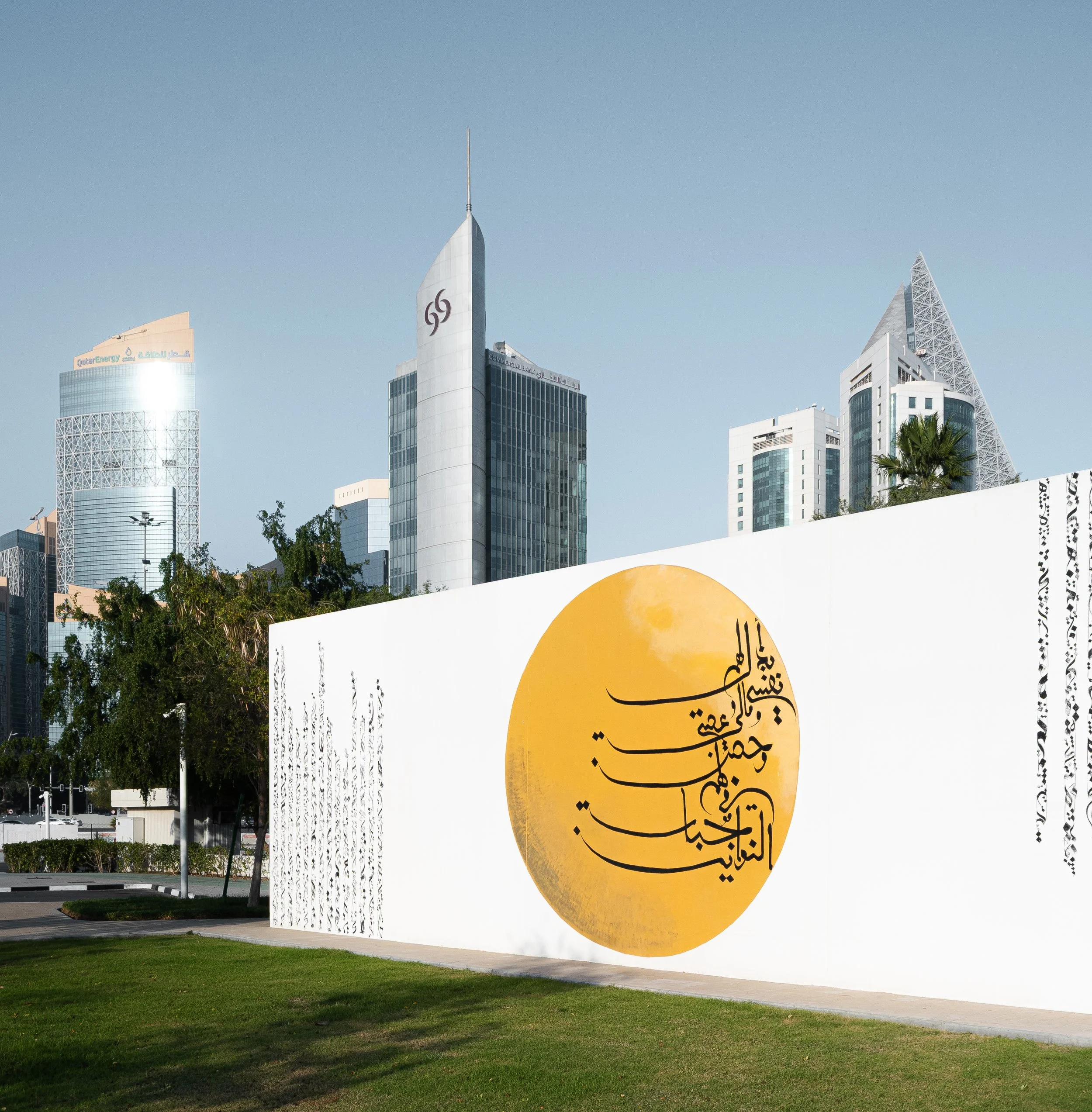 Public art installation in Doha photographed against the West Bay skyline, showing the scale of the artwork within the city's modern architecture.