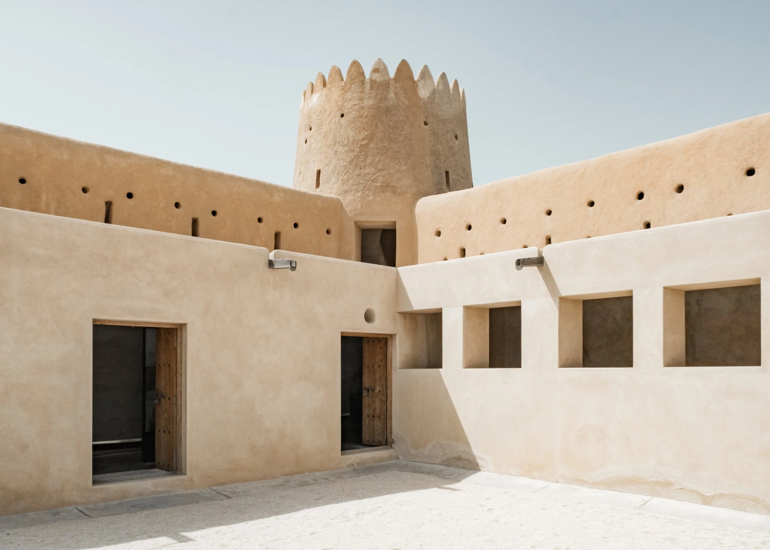 Overview of Al Zubarah Fort’s central courtyard, showing surrounding walls, small apertures, and circulation paths, Qatar.