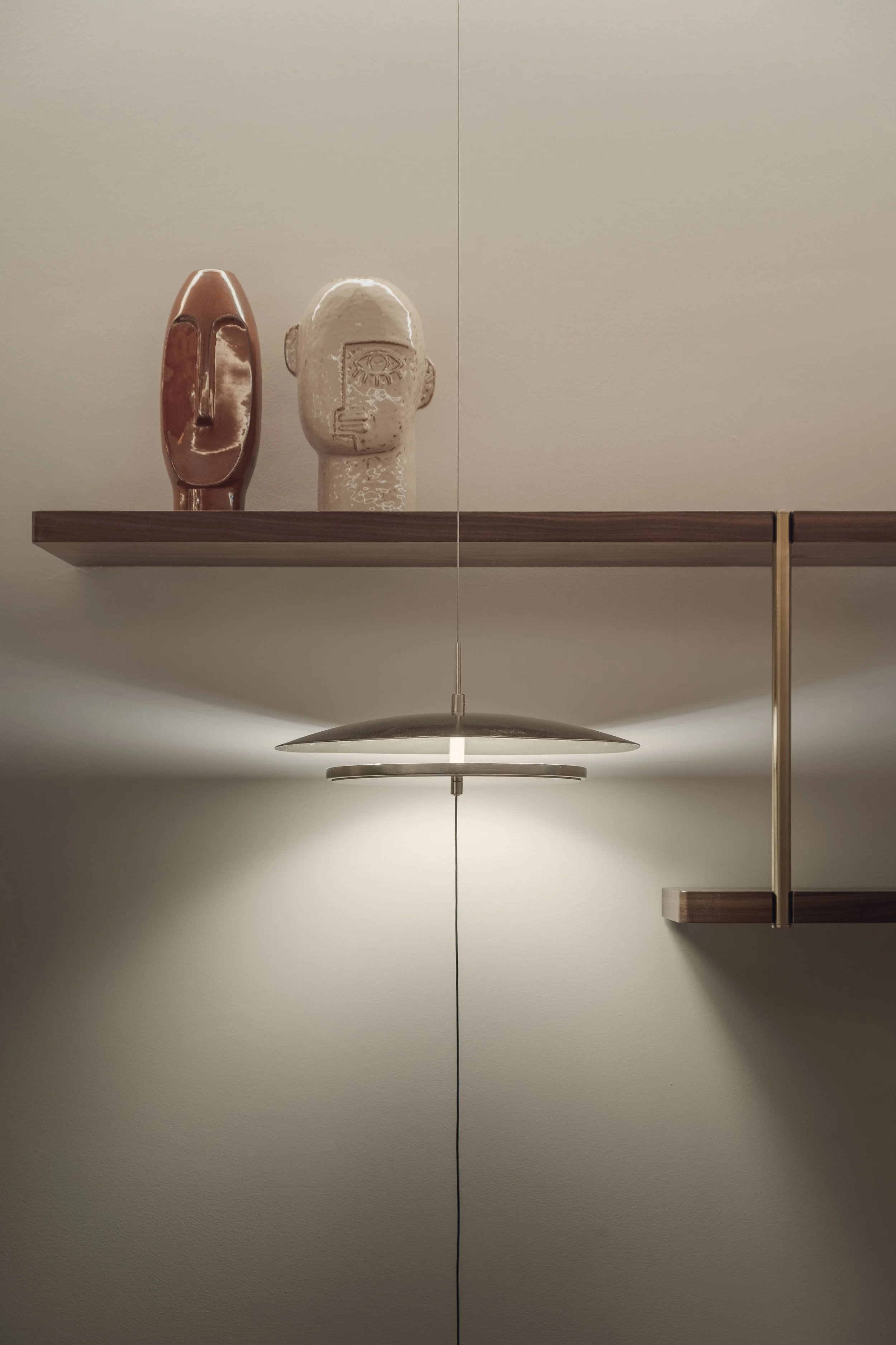 Interior design detail with sculptural objects and wall lighting at the White & Case office reception in Doha