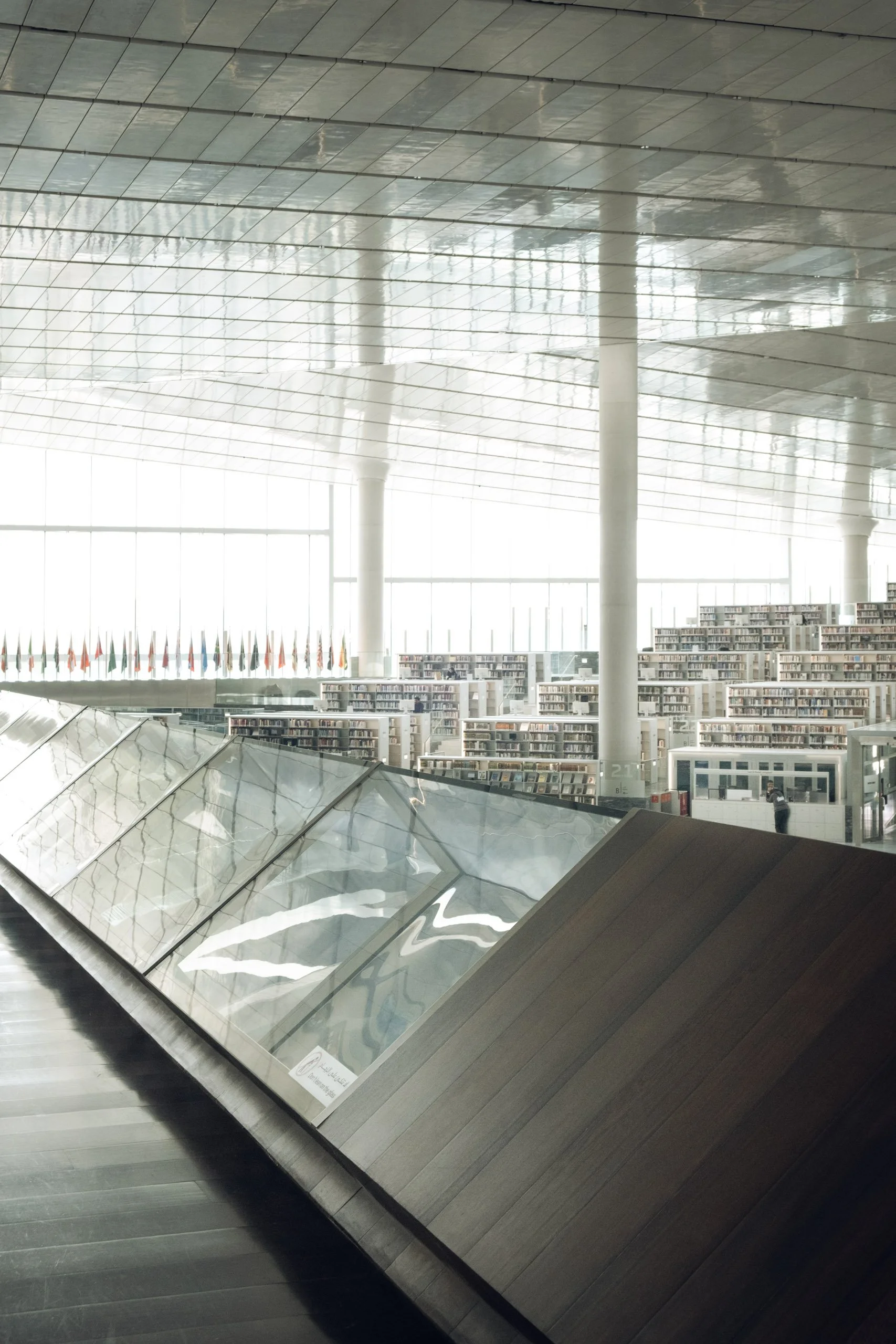Large scale interior photograph of a contemporary public building in Doha, Qatar, showing strong architectural rhythm, structural repetition and controlled natural light, photographed by Pedro Ferr for architects, interior designers and corporate des