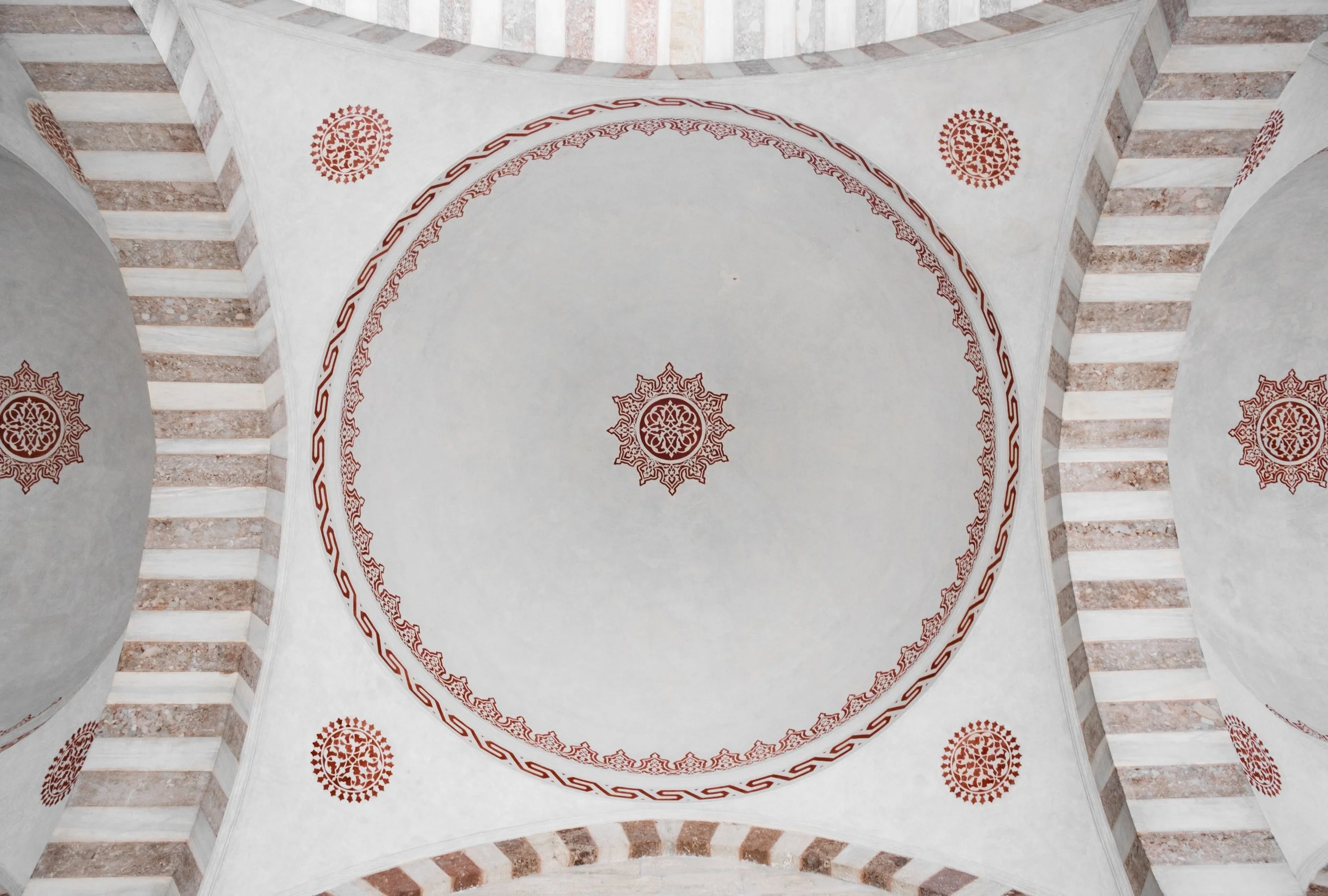 Ceiling arches with painted geometric patterns inside the Blue Mosque in Istanbul.