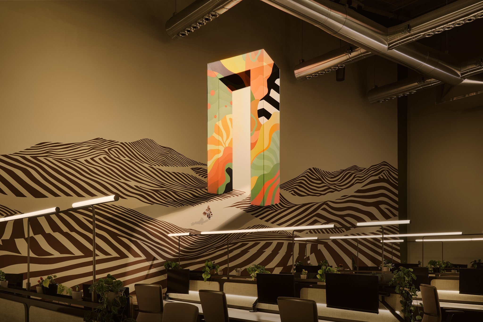 Sculptural painted doorway set into a striped mural above the open workspace, Morph Collective HQ, Al Quoz, Dubai.